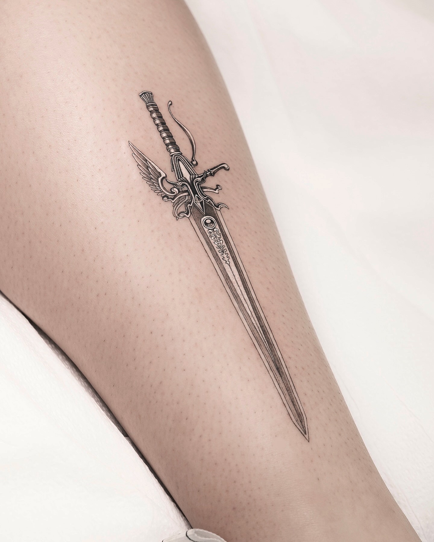 Sword black and grey tattoo on the thigh by p o b i