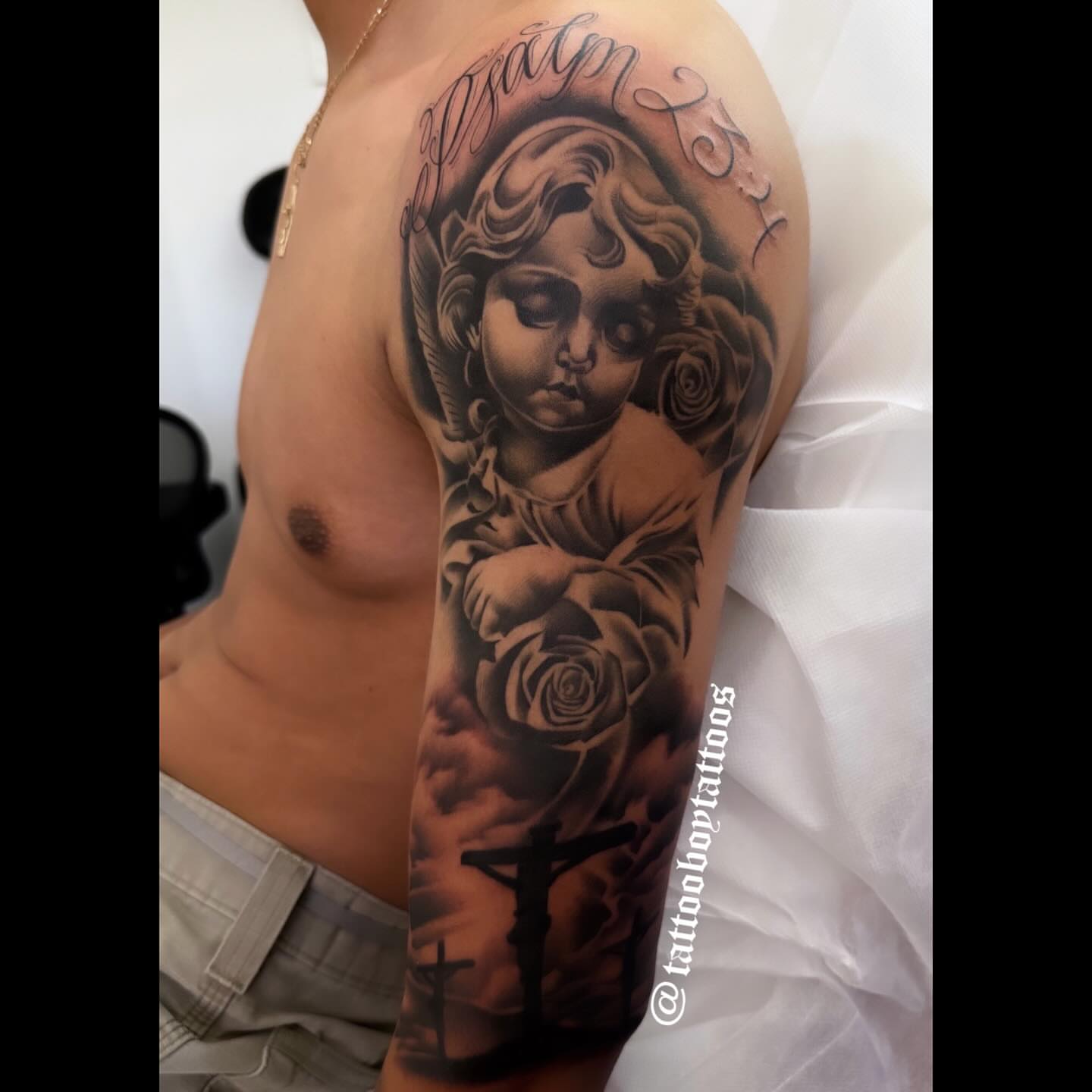 Angel with roses realism tattoo on the upper arm by TattooBoyTattoos