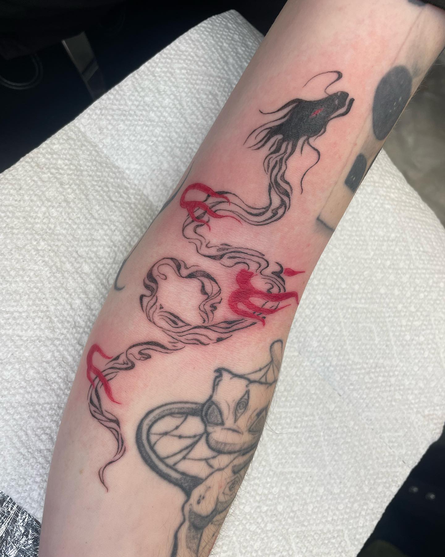 Snake and flame black and grey tattoo on the forearm by madison, Cincinnati