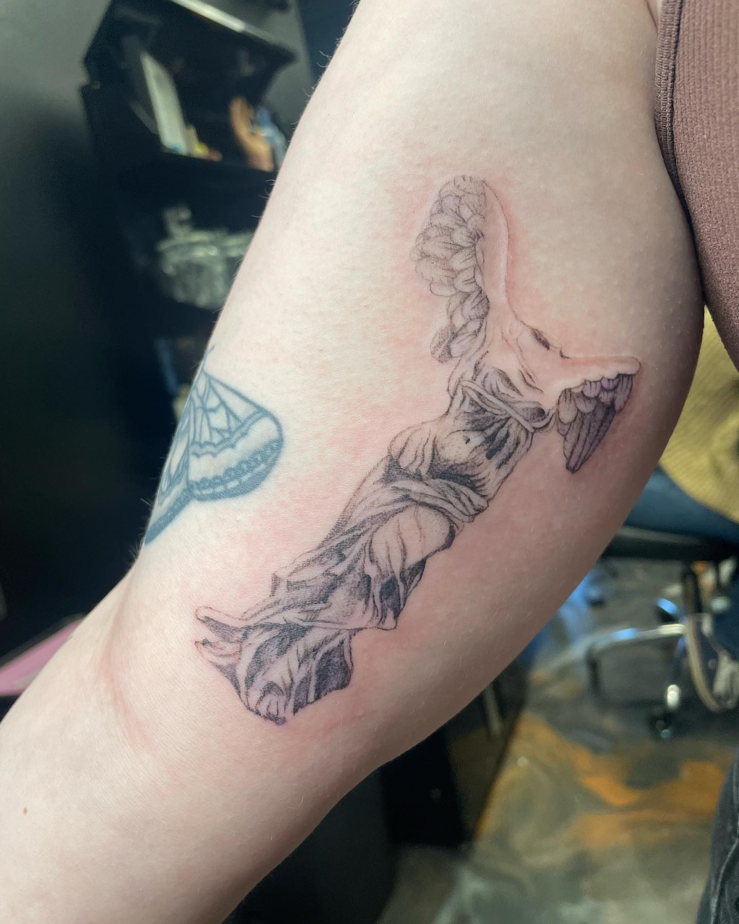 Statue black and grey tattoo on the forearm by madison, Cincinnati