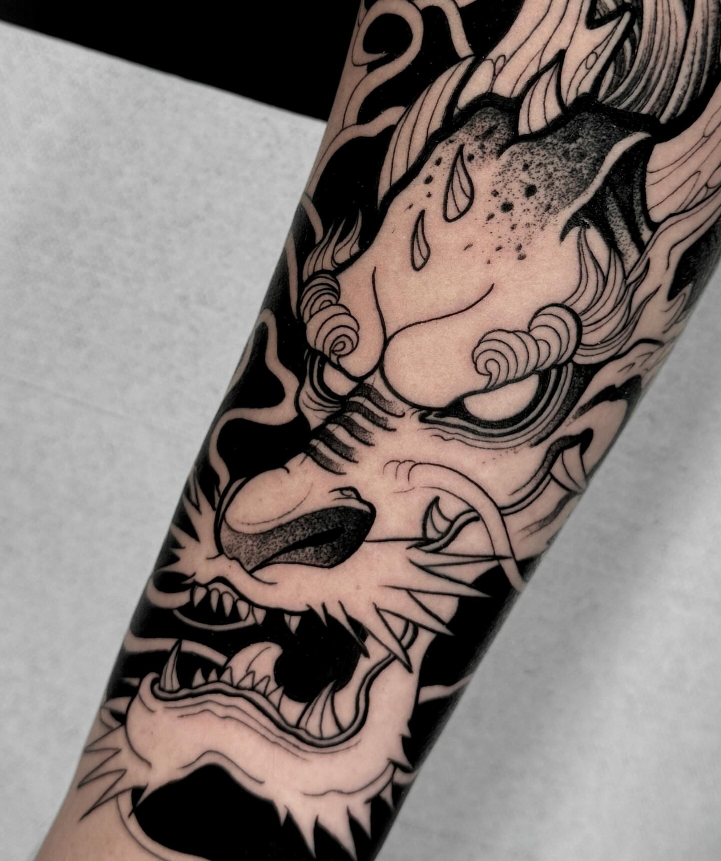 Dragon black and grey tattoo on the forearm by Stiven Gomez