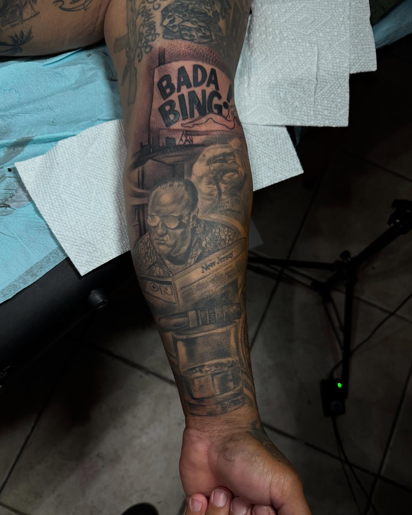 Bada bing sign black and grey tattoo on the forearm by Carla V