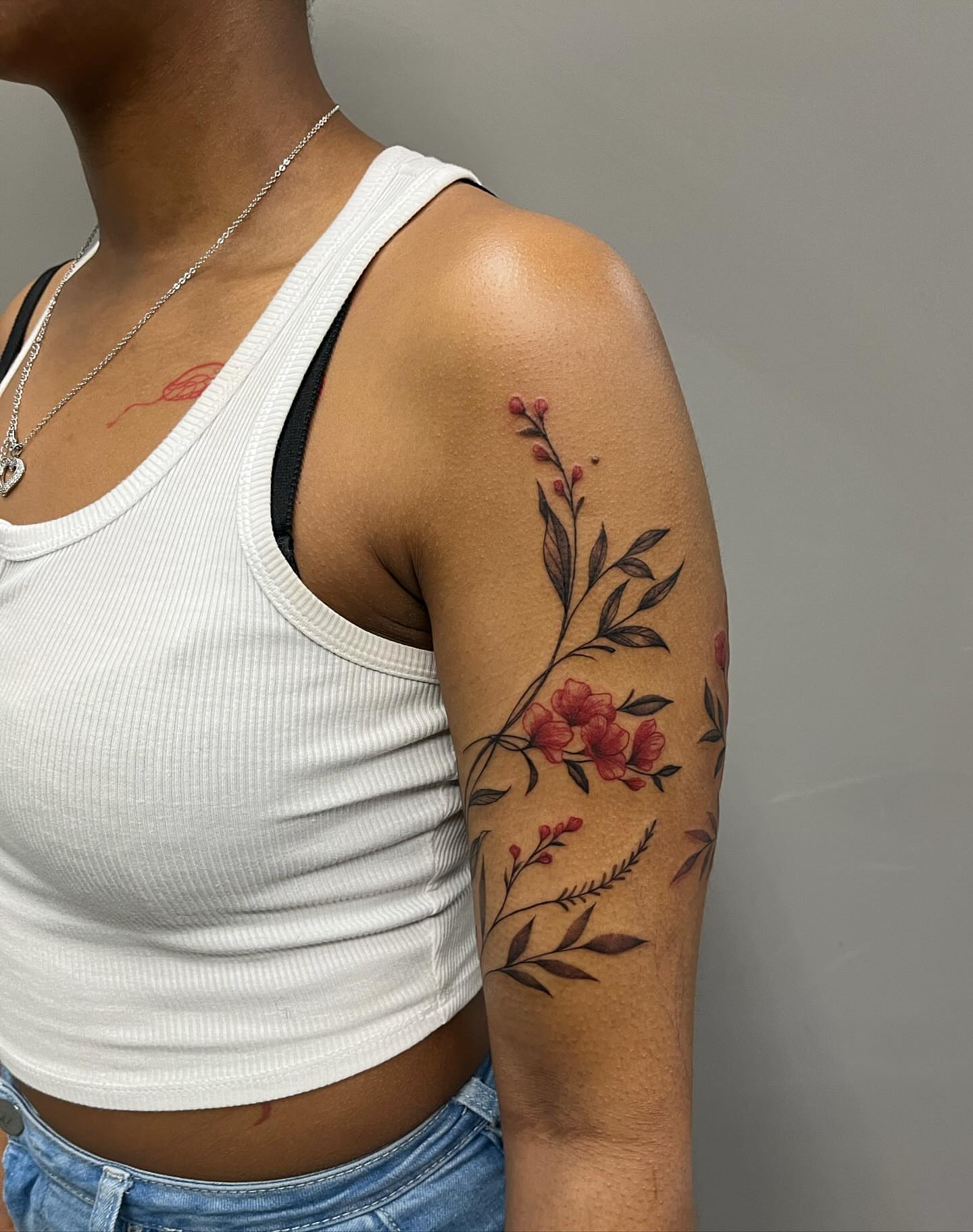 Floral arrangement new school tattoo on the upper arm by Detroit Tattoo Artist