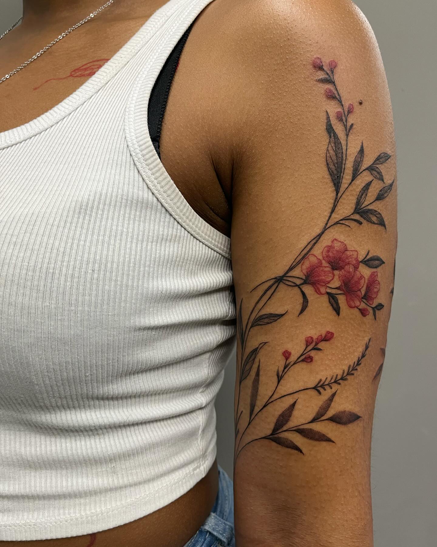 Floral branch black and grey tattoo on the upper arm by Detroit Tattoo Artist