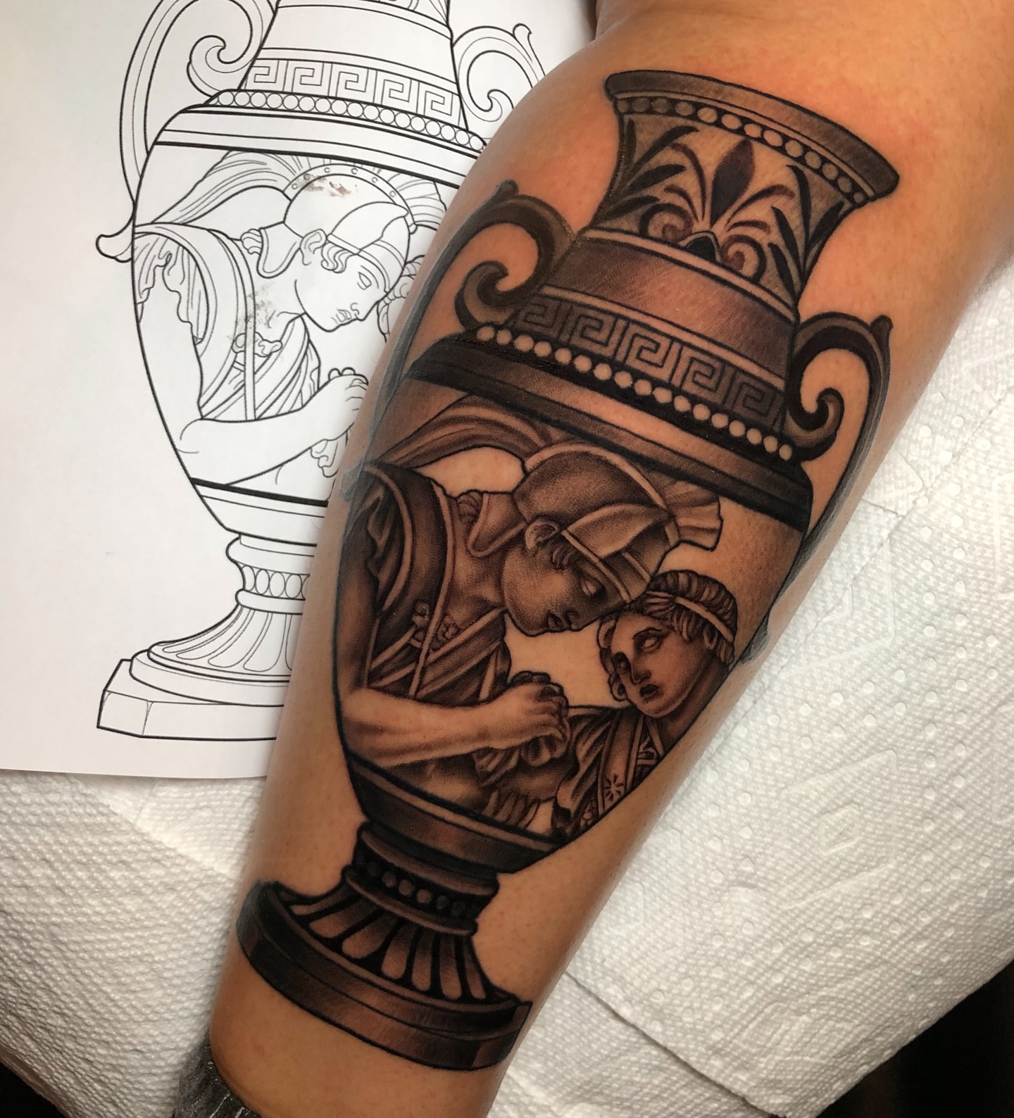 Ancient vase with figures black and grey tattoo on the forearm by Melissa Brown