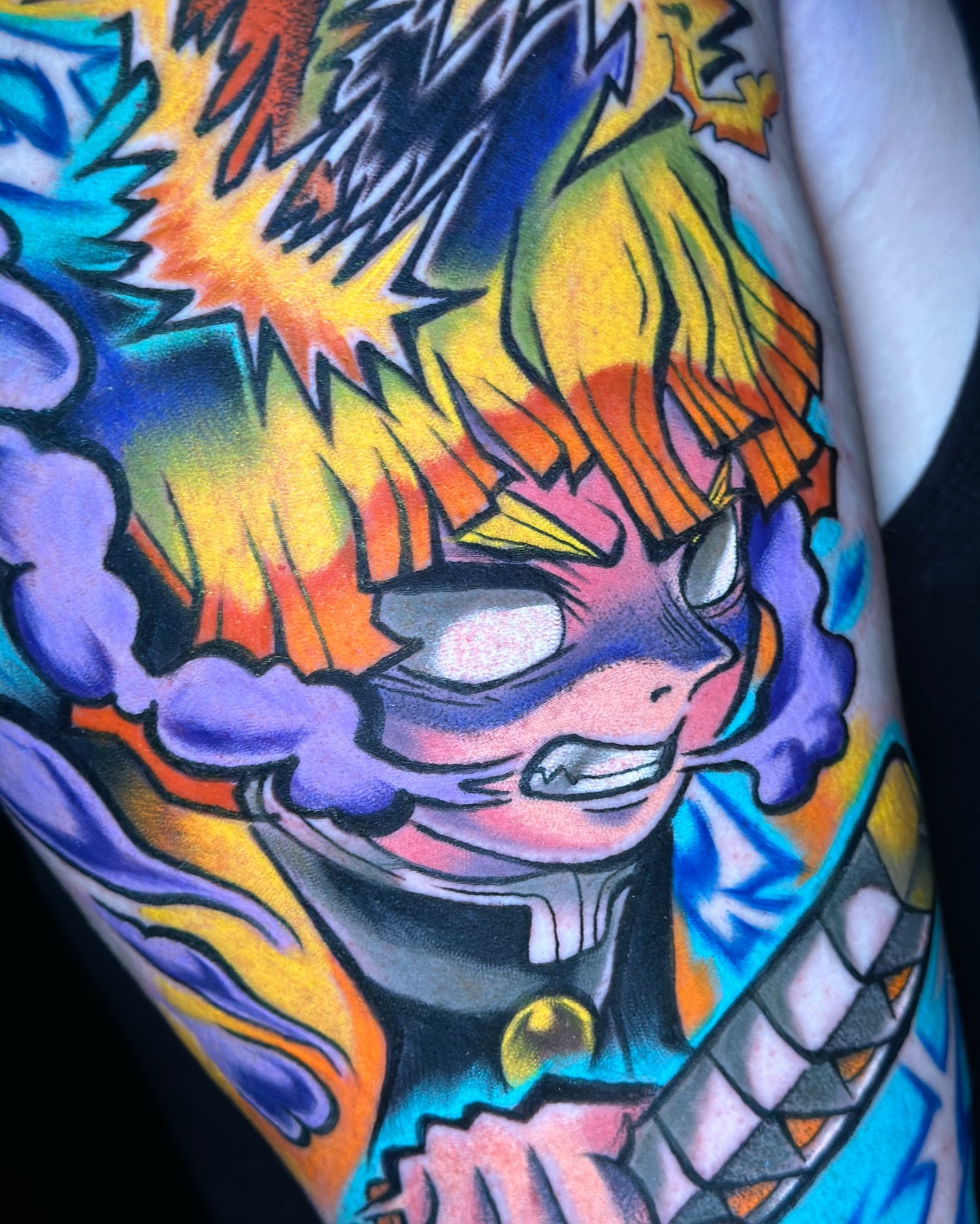 Anime character anime tattoo on the upper arm by Jeremy Thomas