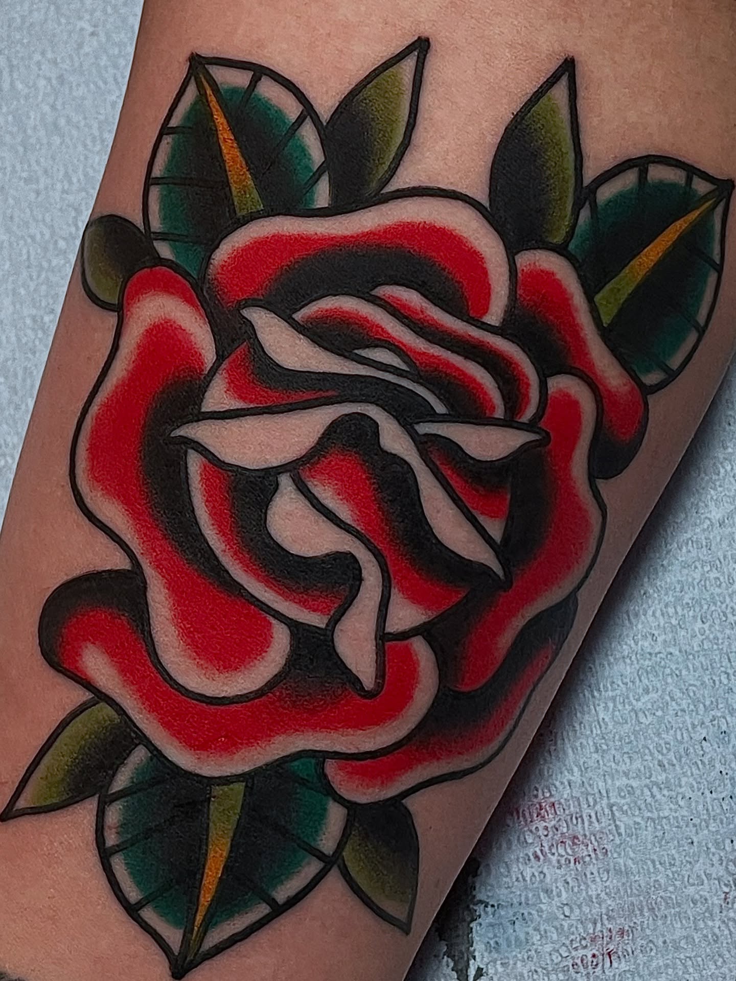Rose American traditional tattoo on the forearm by Frank Mostek