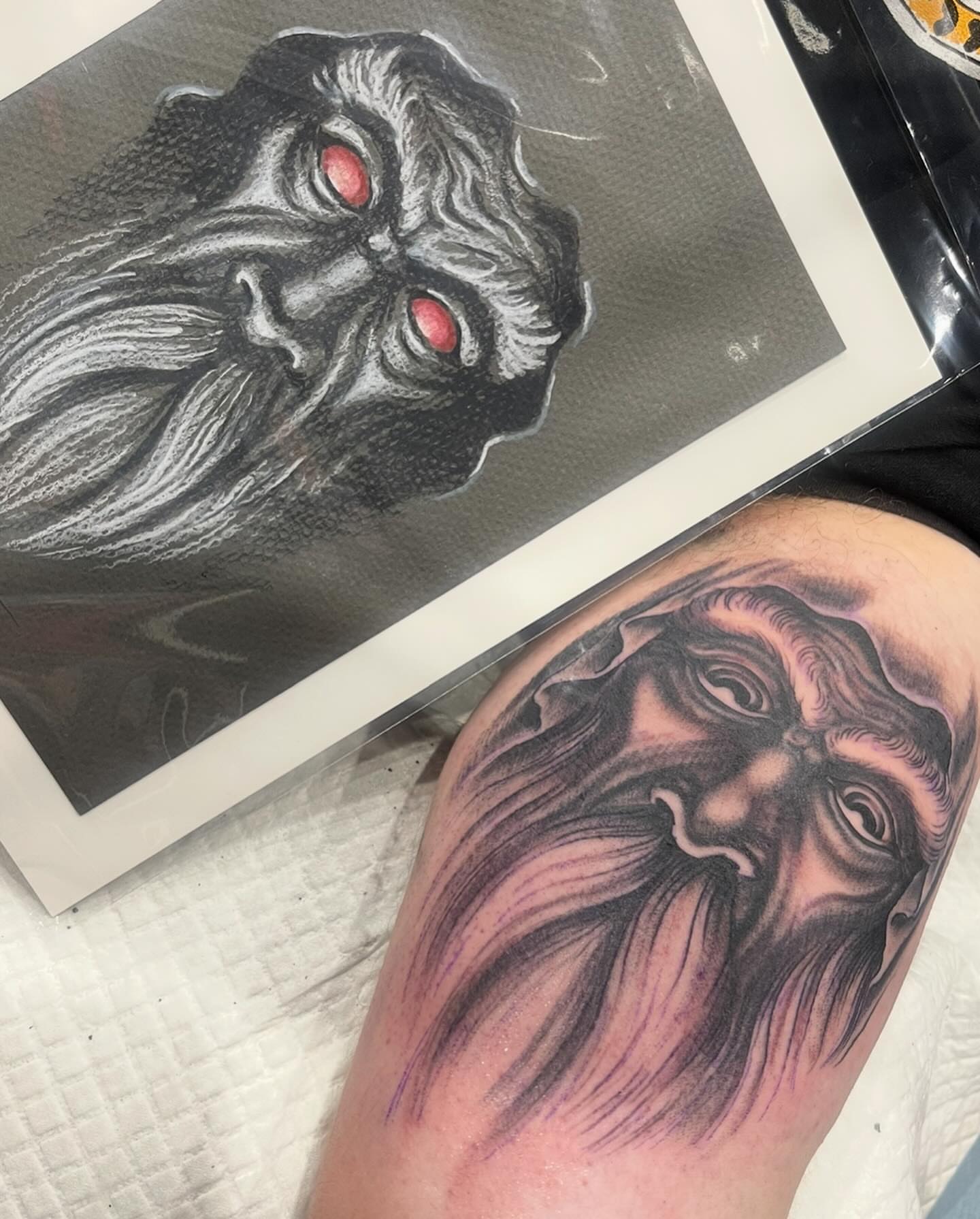 Bearded face dark realism tattoo on the thigh by Mike Wilson