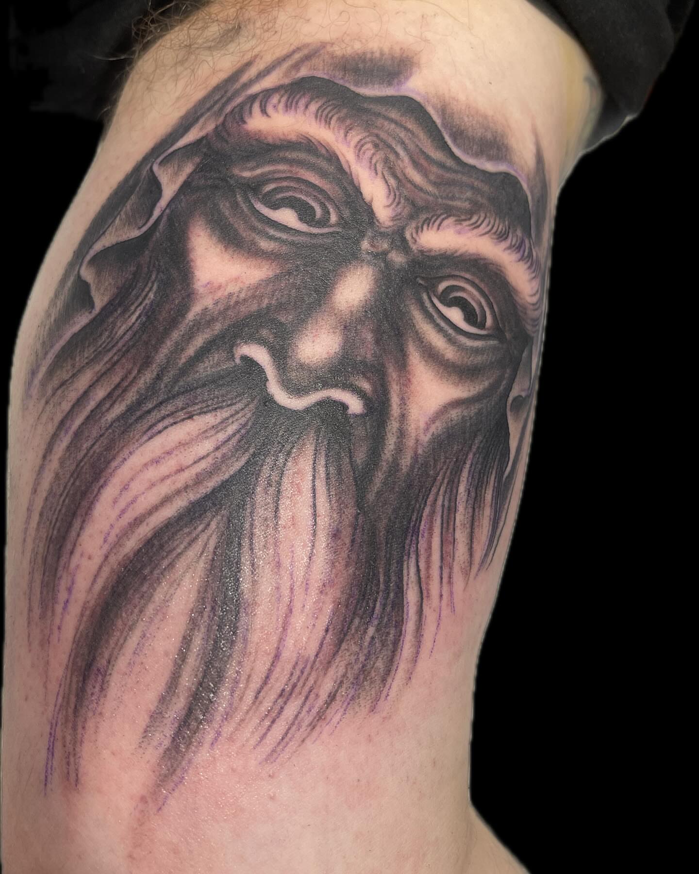 Bearded old man realism tattoo on the forearm by Mike Wilson