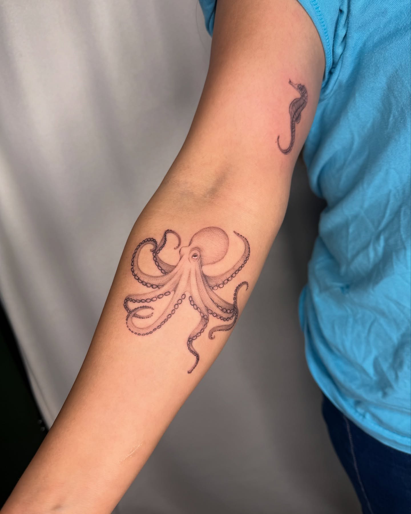 Octopus black and grey tattoo on the forearm by elena