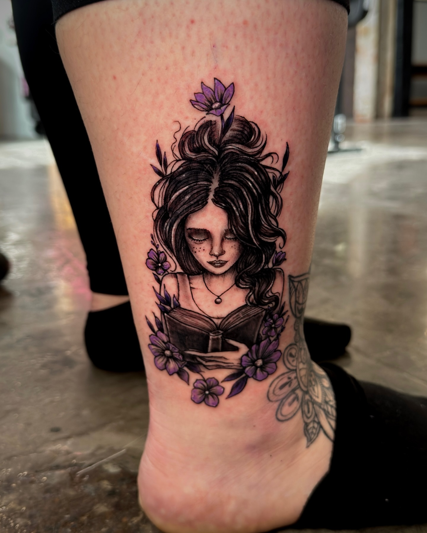 Woman reading book realism tattoo on the calf by Jeff Brock