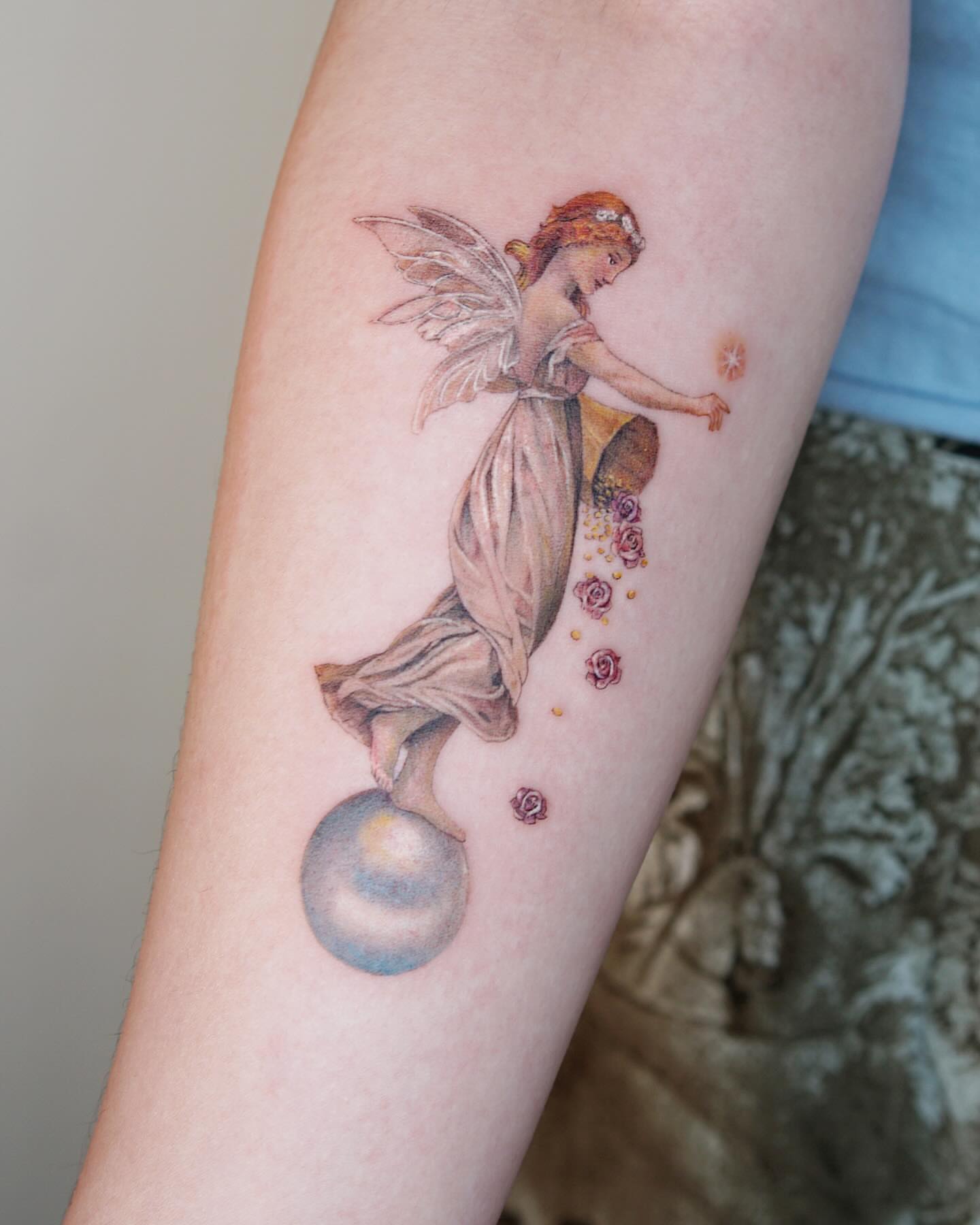Fairy with roses watercolor tattoo on the forearm by Alissa Jung