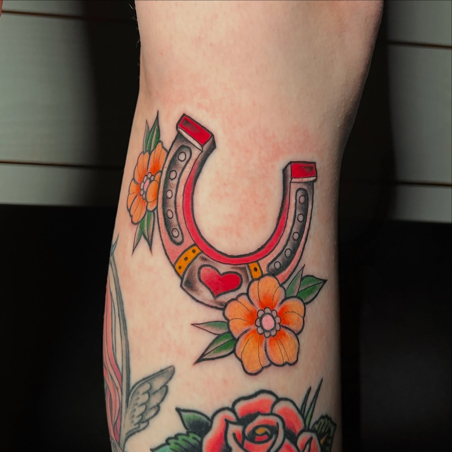 Horseshoe and flowers American traditional tattoo on the forearm by Tattoo & Body Artist, Gastonia, North Carolina