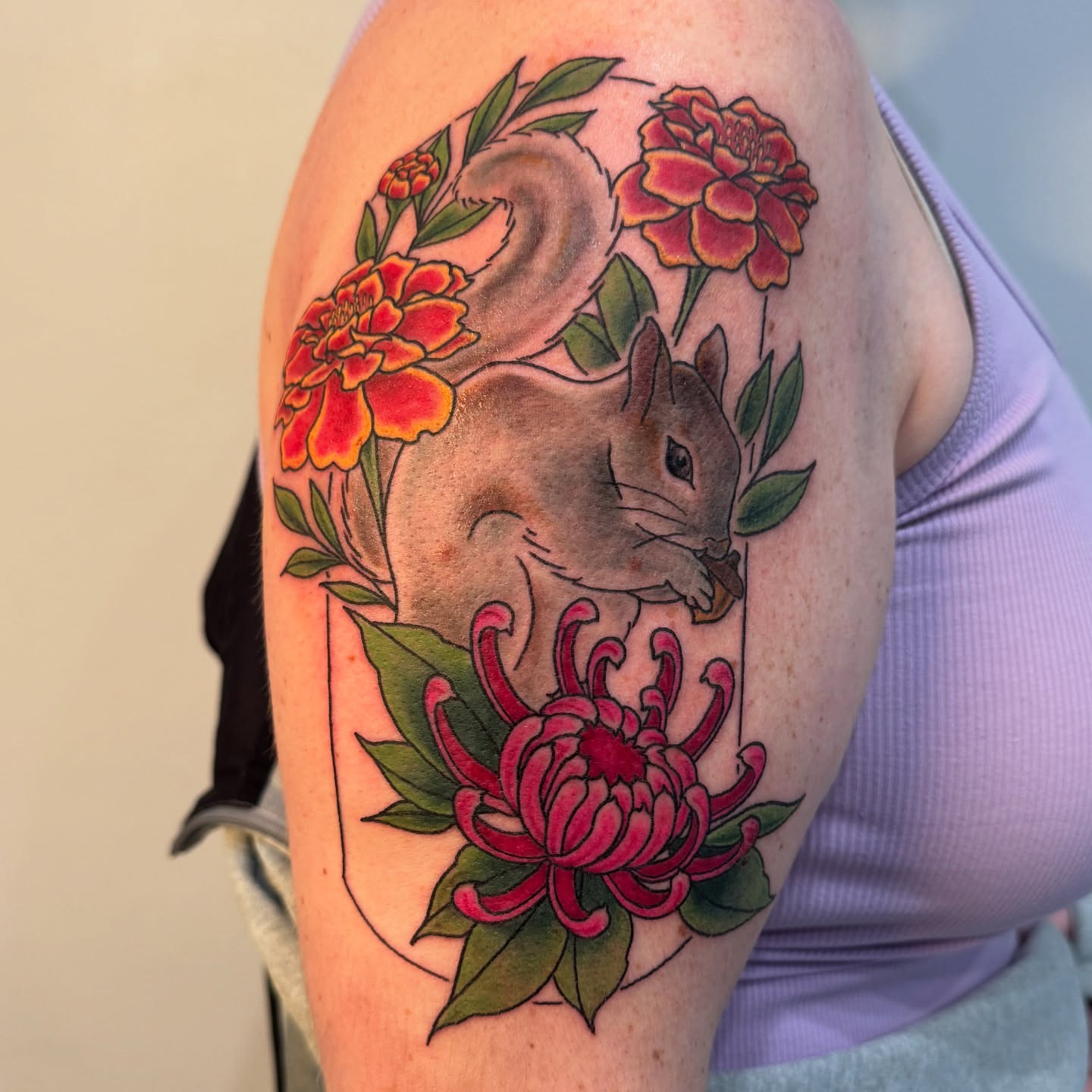 Squirrel and flowers realism tattoo on the upper arm by Ashley Rose - Minnesota Tattoo Artist