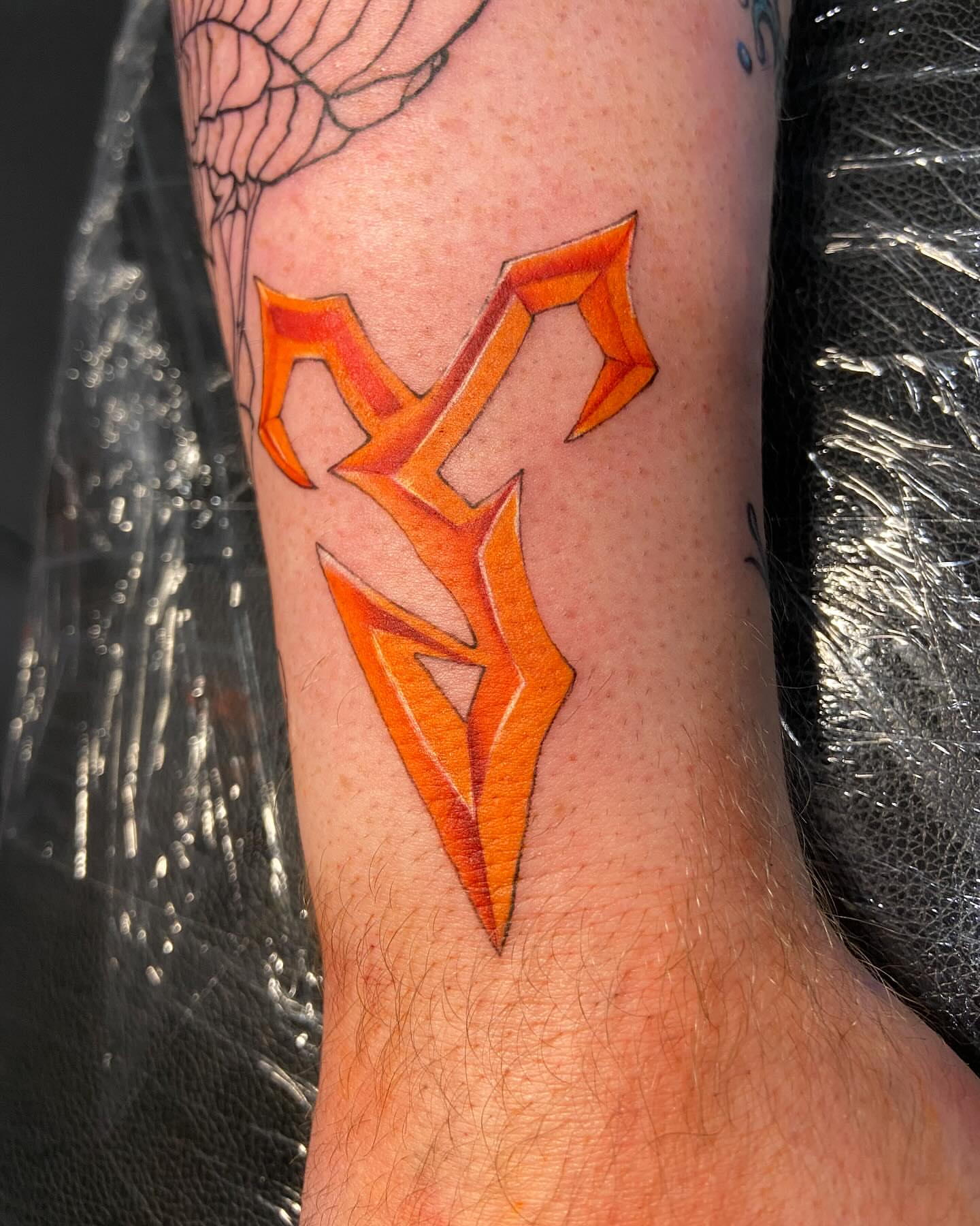 Flame geometric tattoo on the forearm by Slade Nowicki