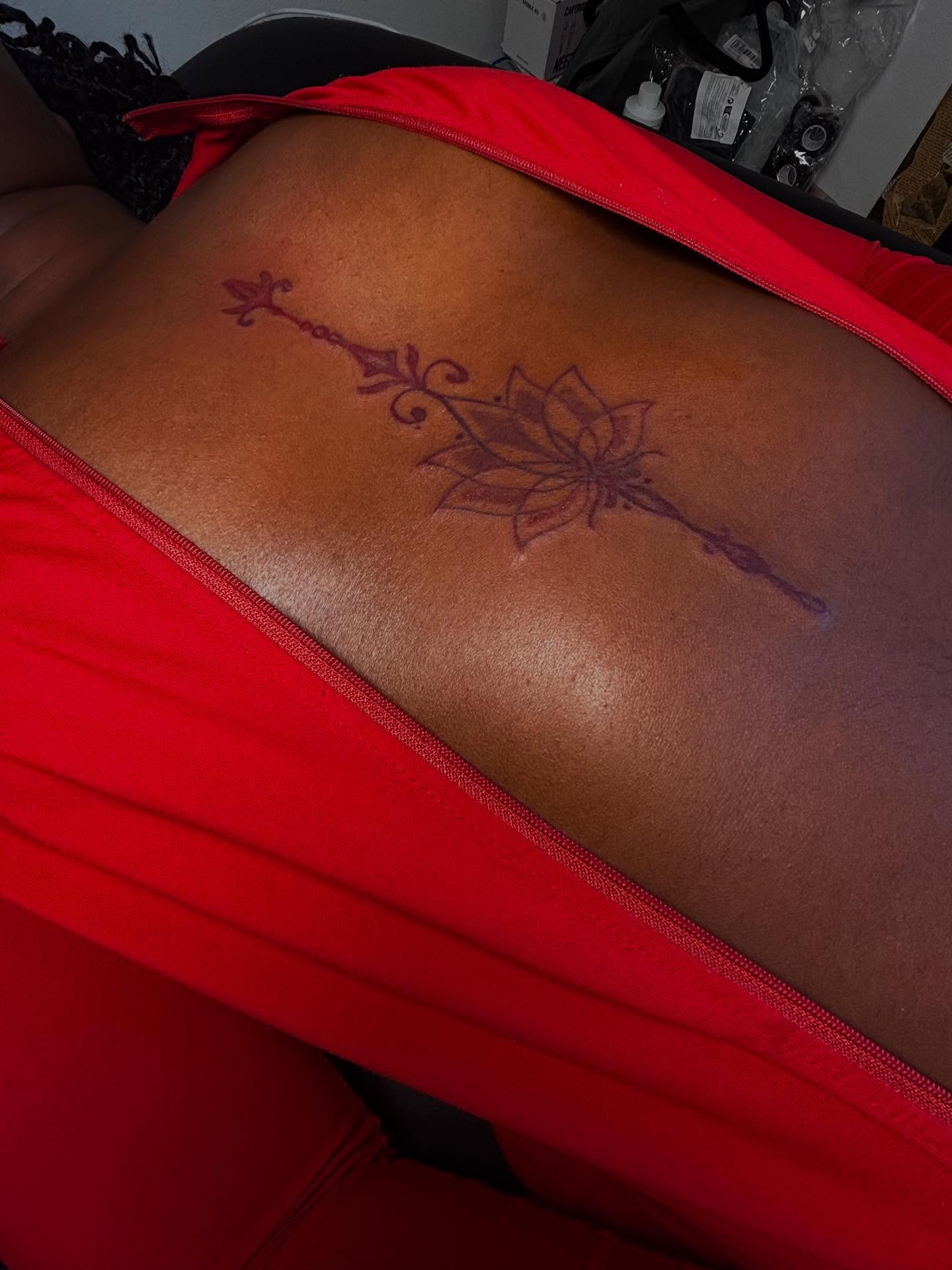 Lotus flower with arrow geometric tattoo on the back by Mc X Happo