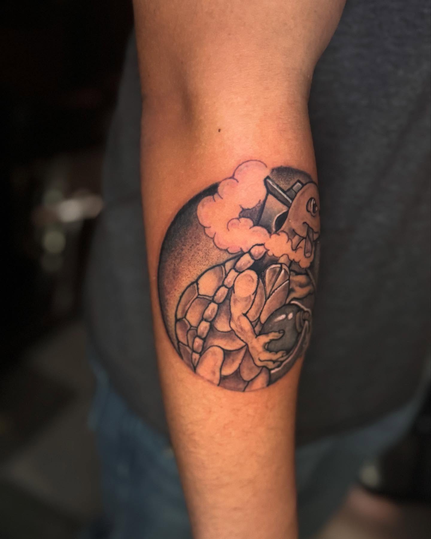 Turtle and football player realism tattoo on the forearm by Brandon Seven