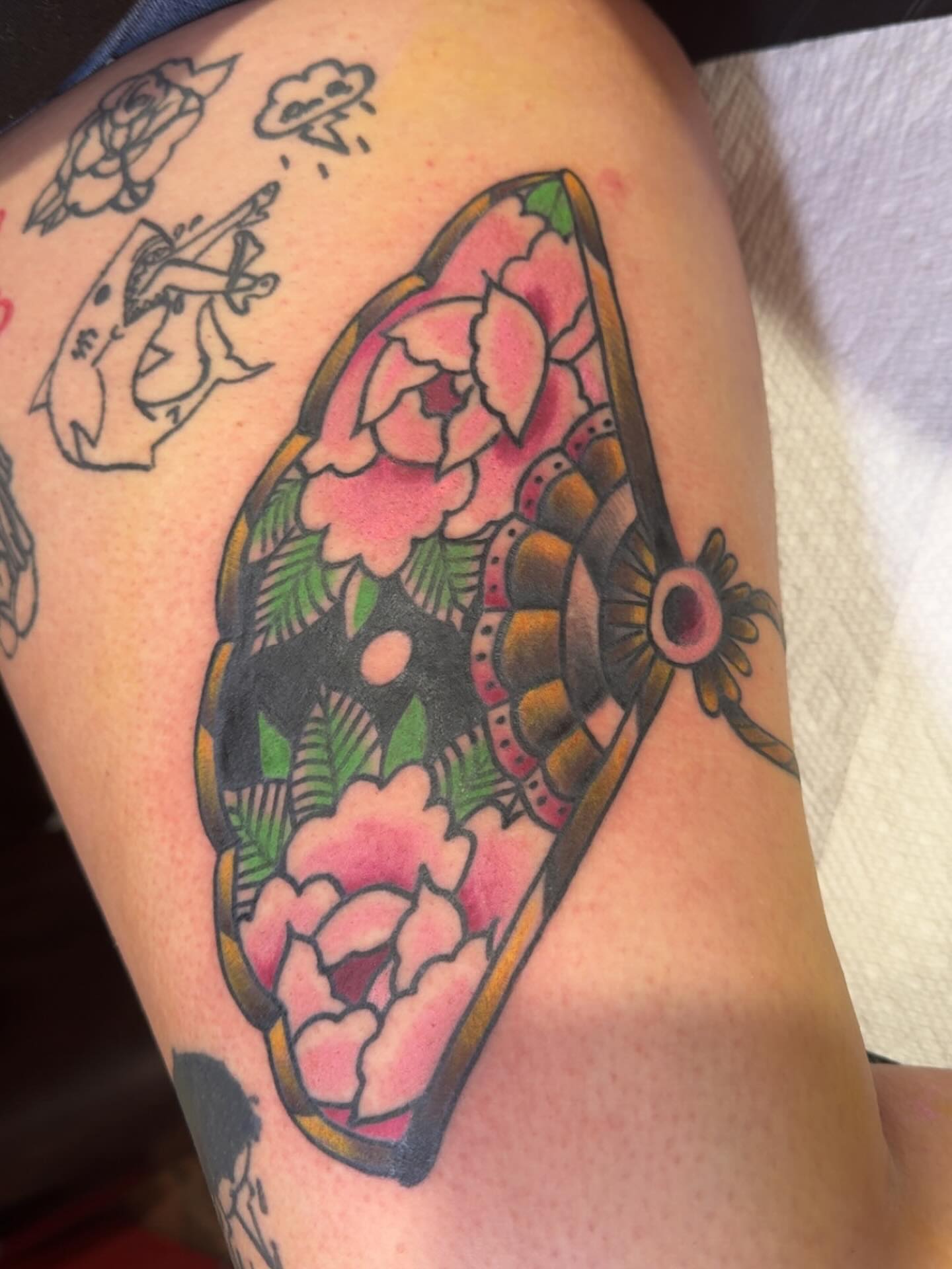 Floral bouquet American traditional tattoo on the thigh by Robbie Roberson
