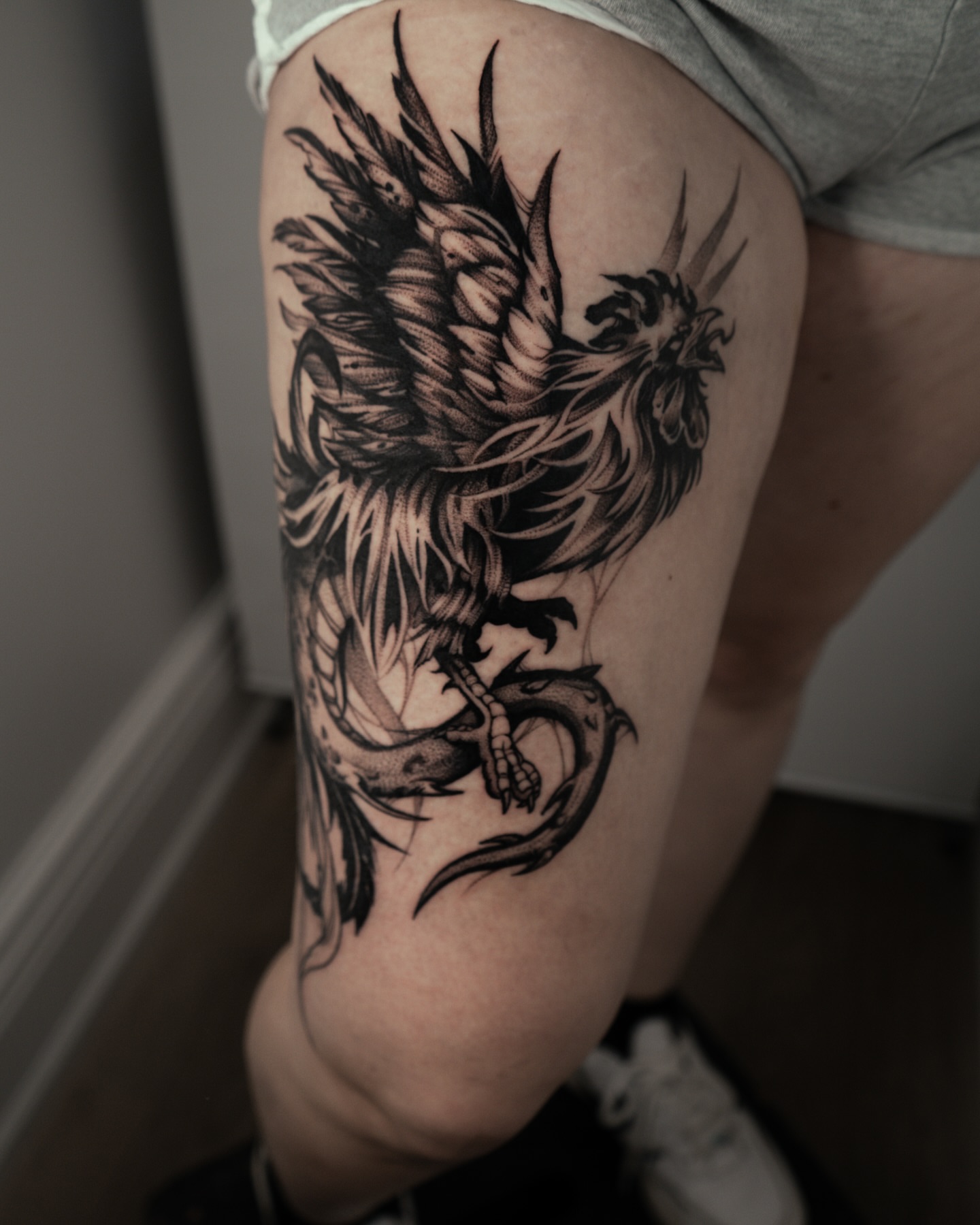Phoenix black and grey tattoo on the thigh by Bruna Bianculli