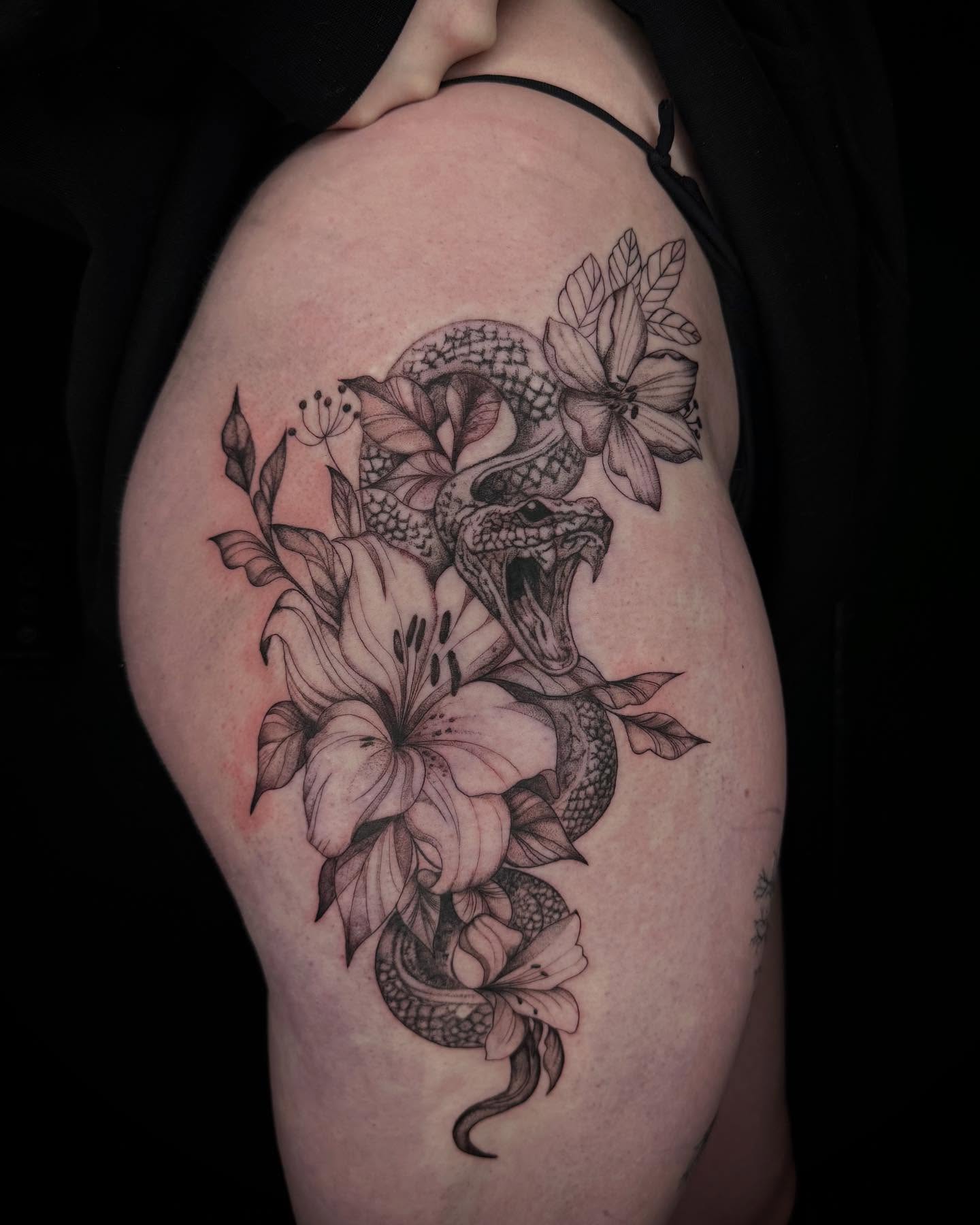 Snake and flowers realism tattoo on the thigh by Chino