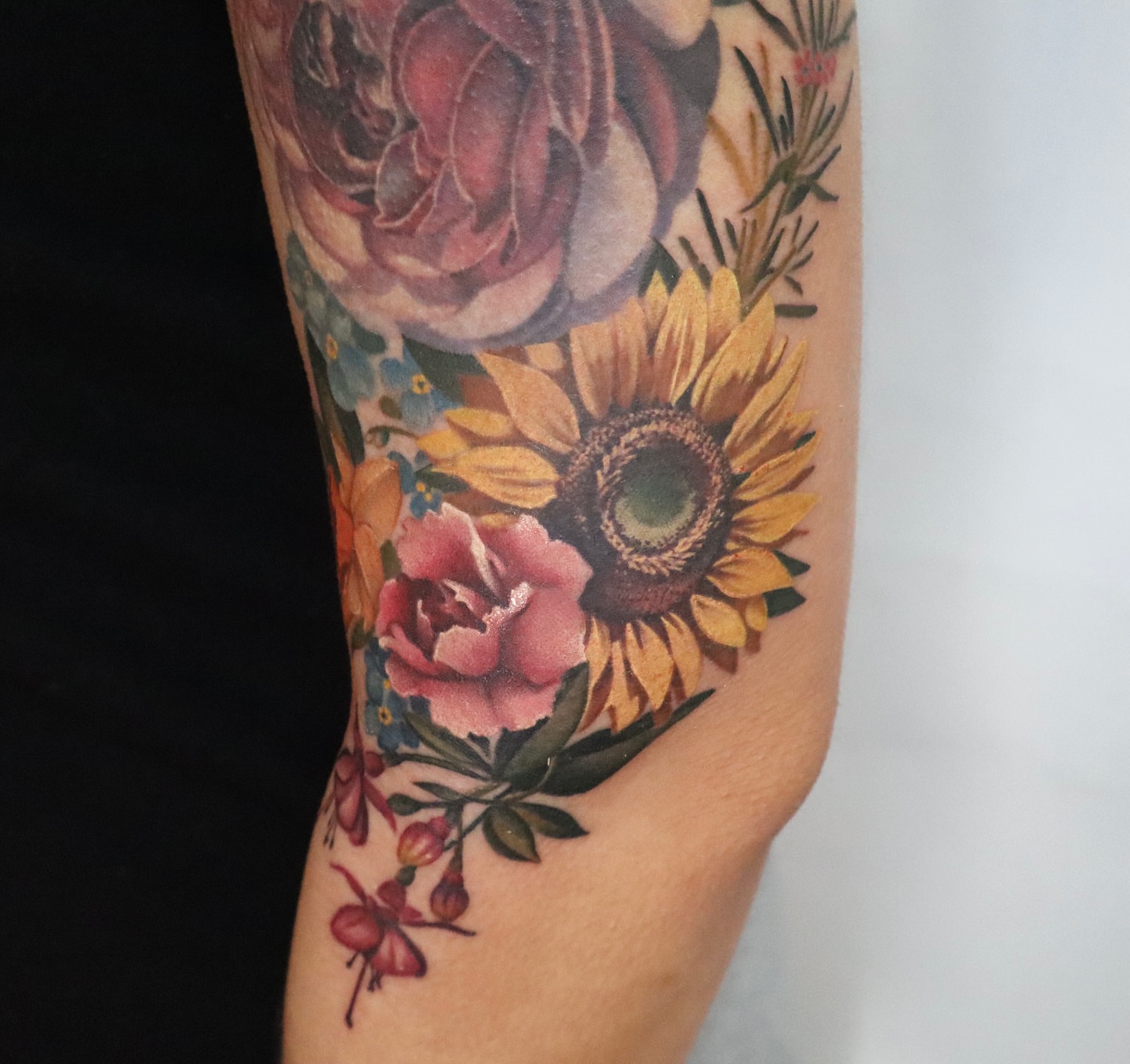 Sunflower and roses realism tattoo on the forearm by Anali De Laney