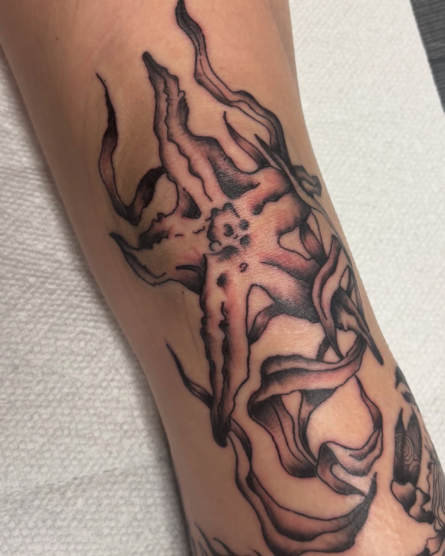 Flame black and grey tattoo on the forearm by Bridget Smith