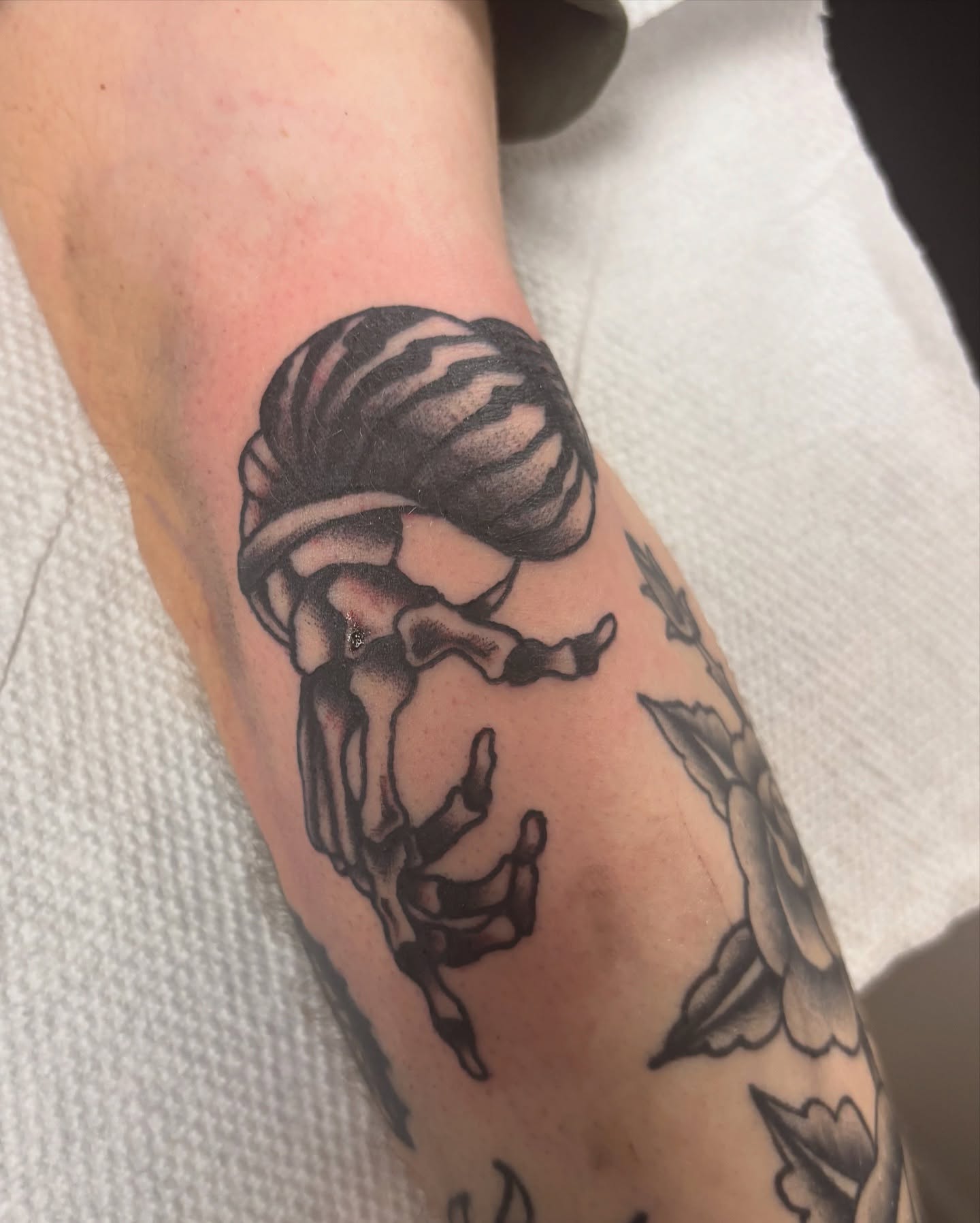 Woman climbing black and grey tattoo on the forearm by Bridget Smith