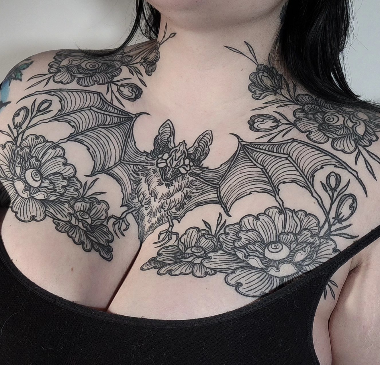 Bat and floral black and grey tattoo on the chest by Mariah Giovanna Hodgens
