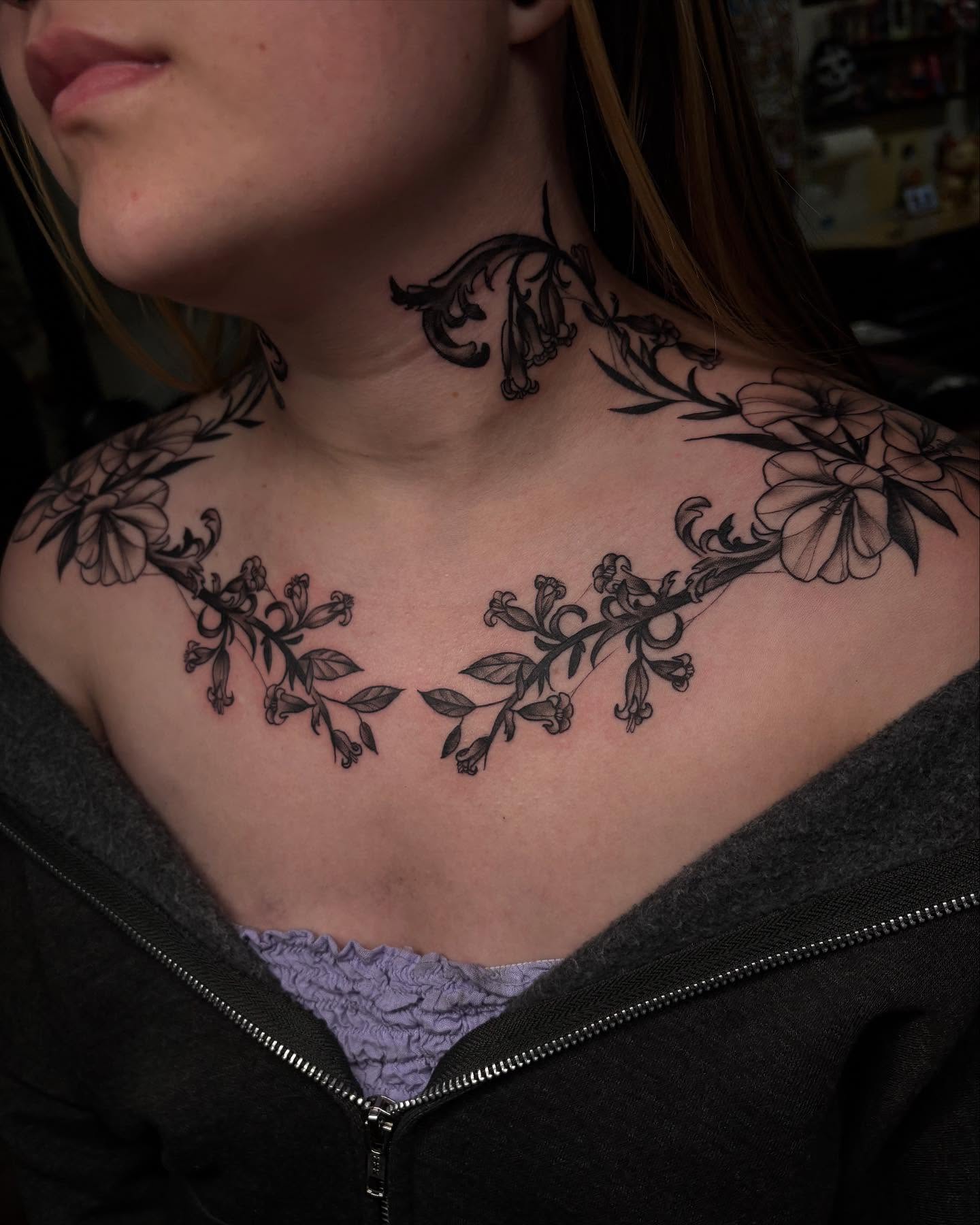 Floral vine black and grey tattoo on the chest by Alexandria