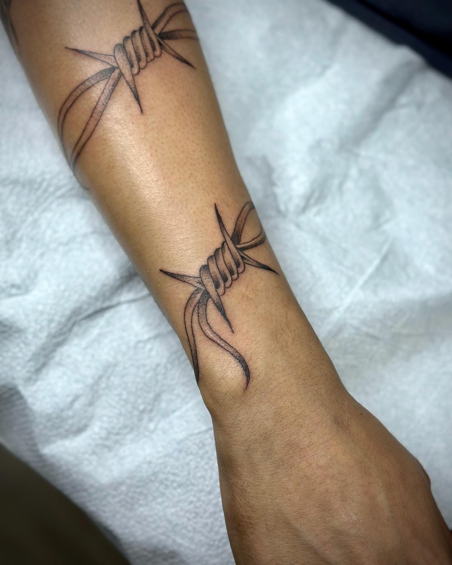 Barbed wire black and grey tattoo on the forearm by christian martinez