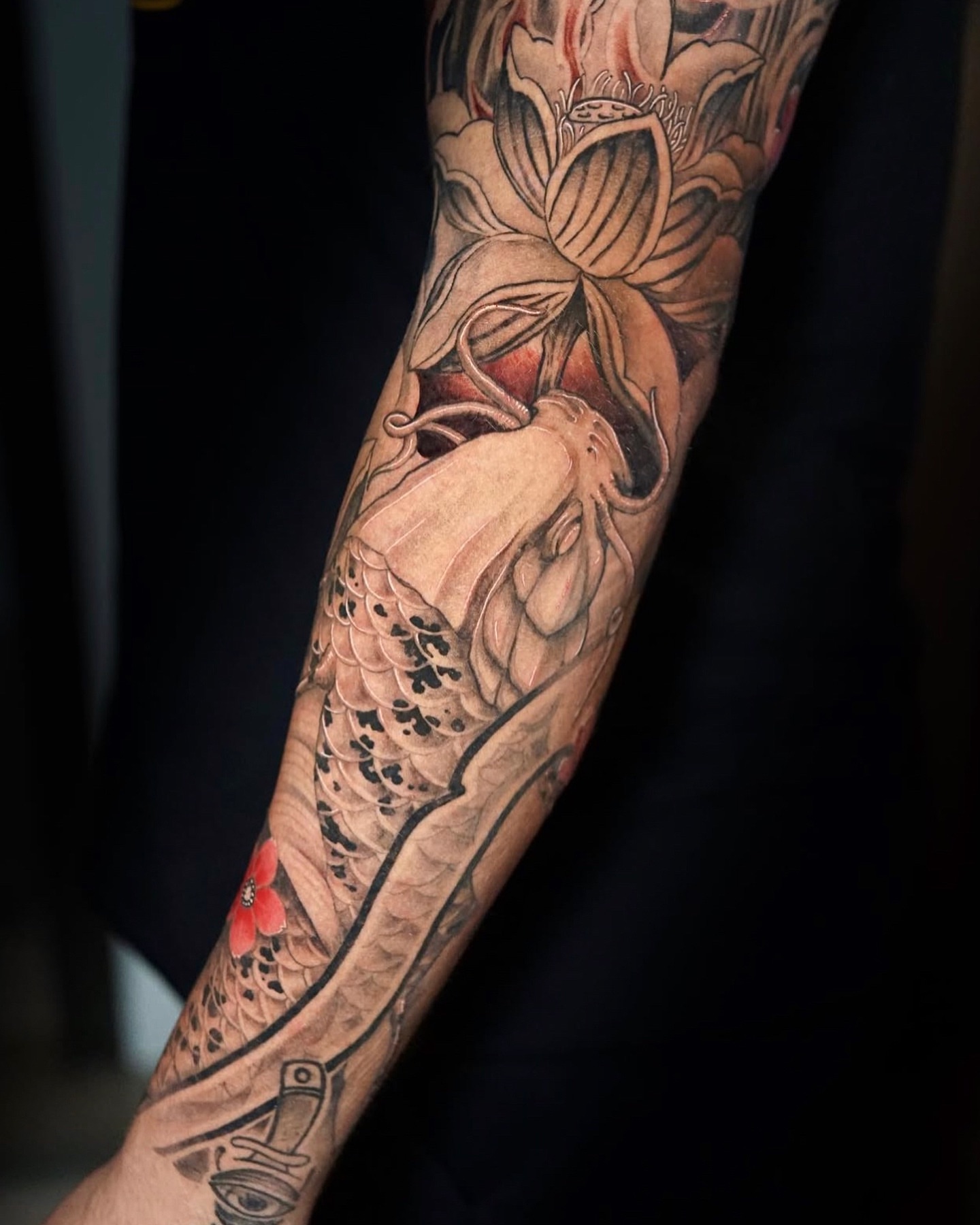 Koi fish and lotus japanese irezumi tattoo on the forearm by Johnson
