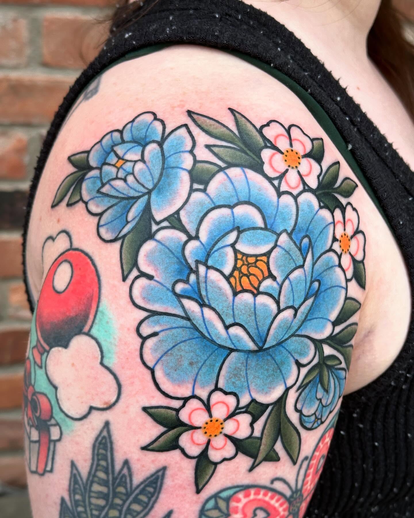 Blue peonies American traditional tattoo on the shoulder by Ginny Marie Kalnasy