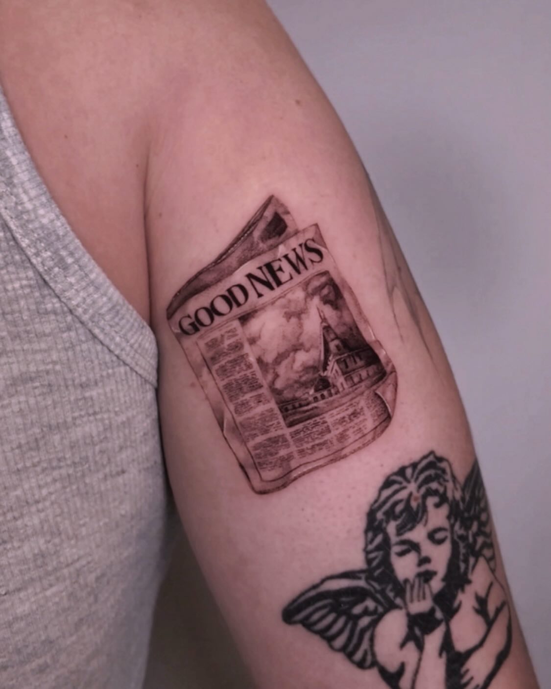 Newspaper black and grey tattoo on the forearm by Gabriel