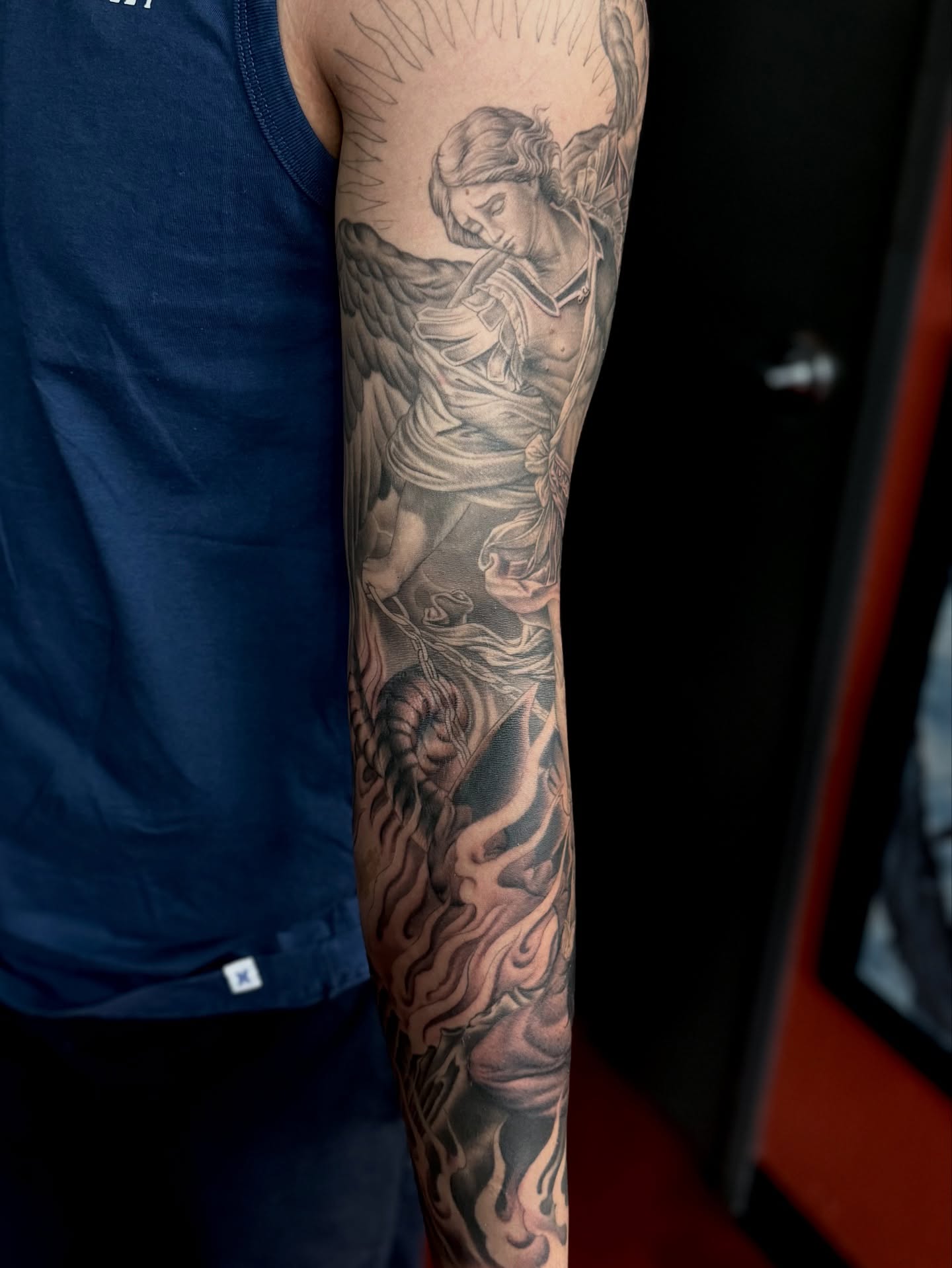 Angel with harp realism tattoo on the forearm by Ernie Rivera