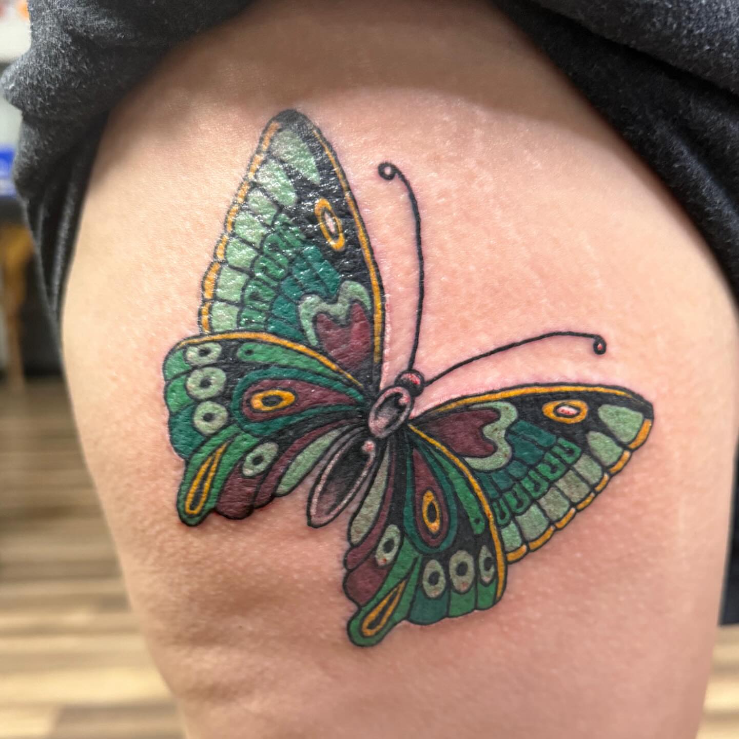 Butterfly new school tattoo on the thigh by Jacie Aasen-Lupino