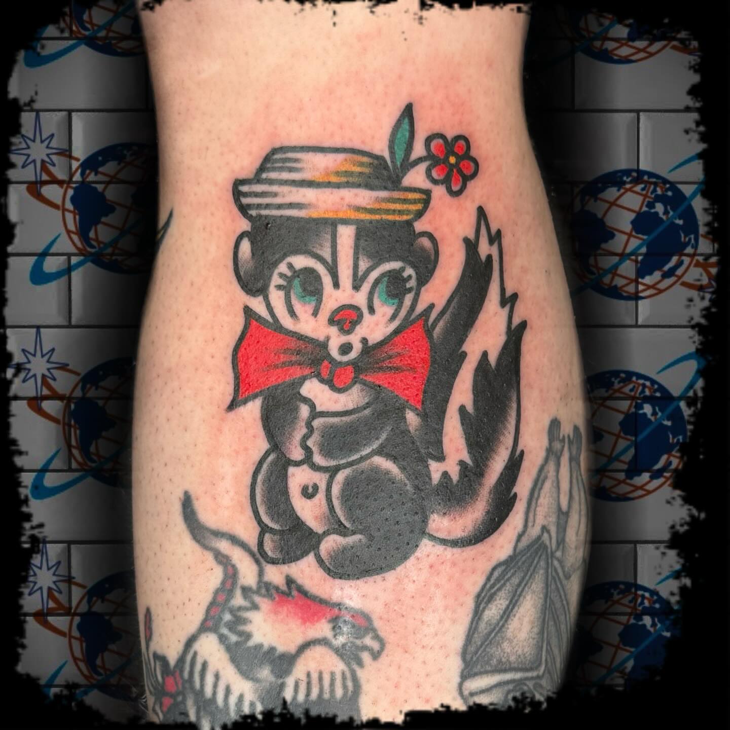 Skunk in hat American traditional tattoo on the forearm by Antonio DeCaro