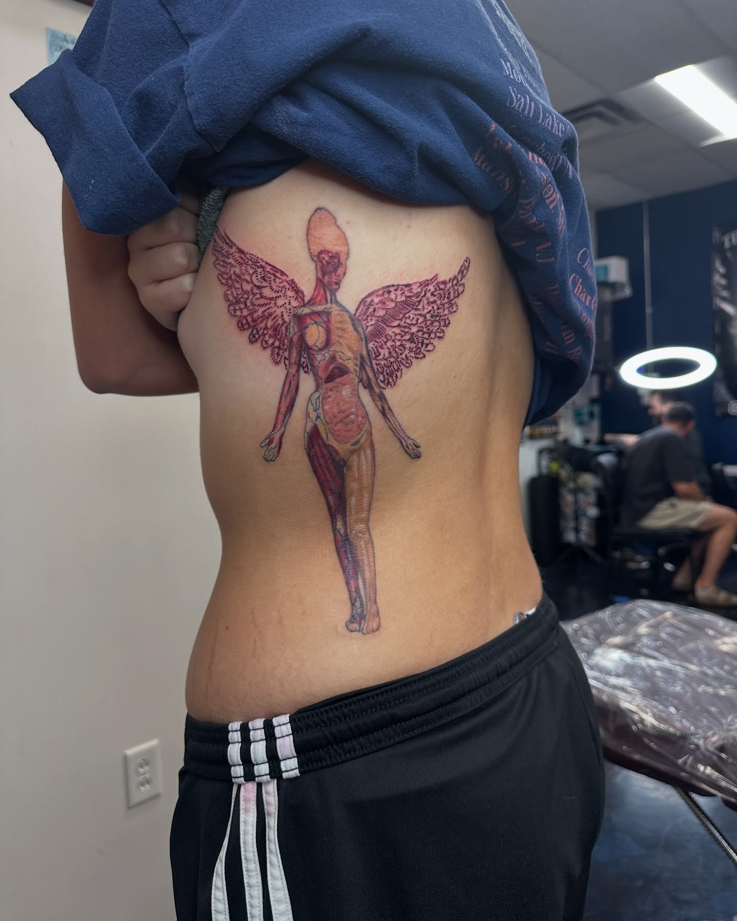Anatomical figure with wings realism tattoo on the ribs by Christian Colón, Nashville, Tennessee