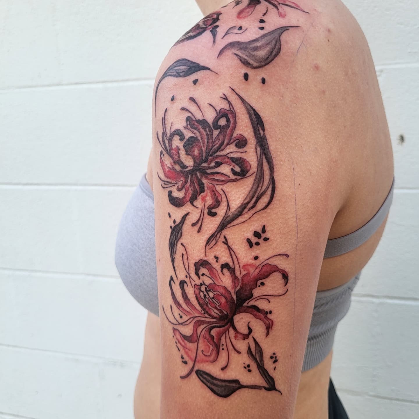 Floral design watercolor tattoo on the shoulder by Jenna 🖤 Tattoos Denton TX