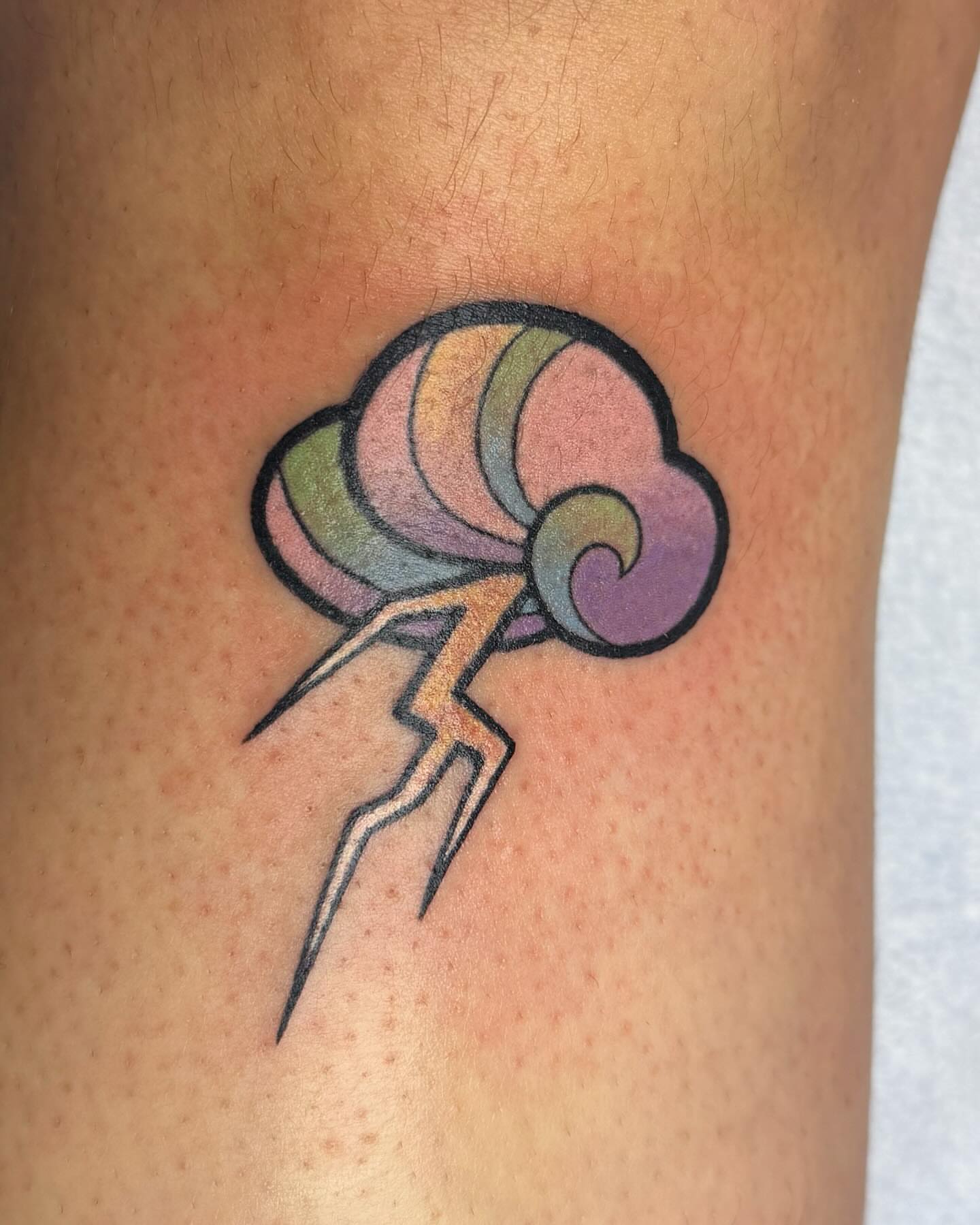 Lightning bolt and cloud new school tattoo on the forearm by Janine Ramos