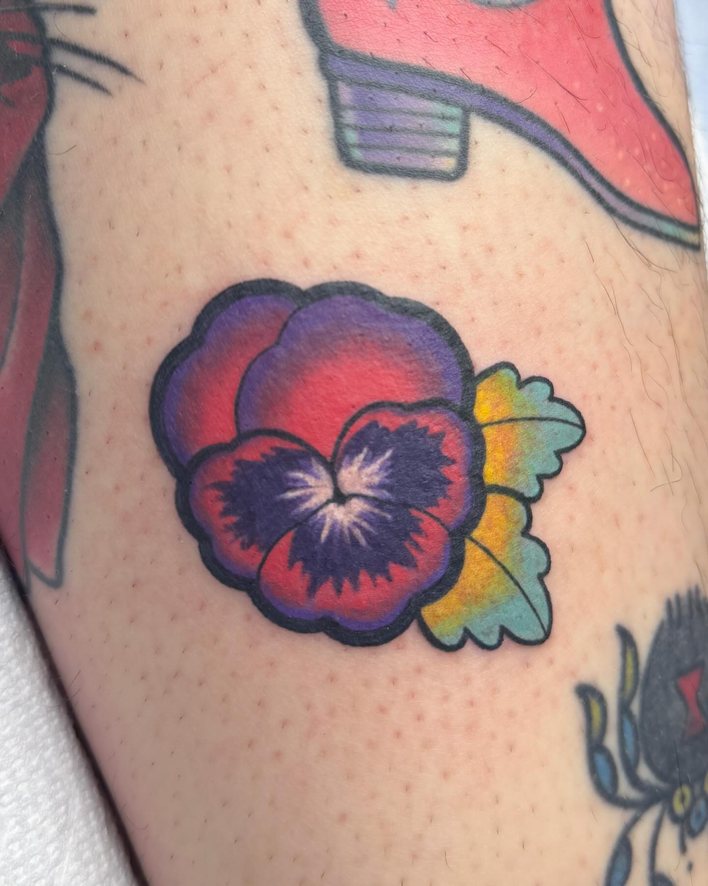 Pansy American traditional tattoo on the forearm by Janine Ramos