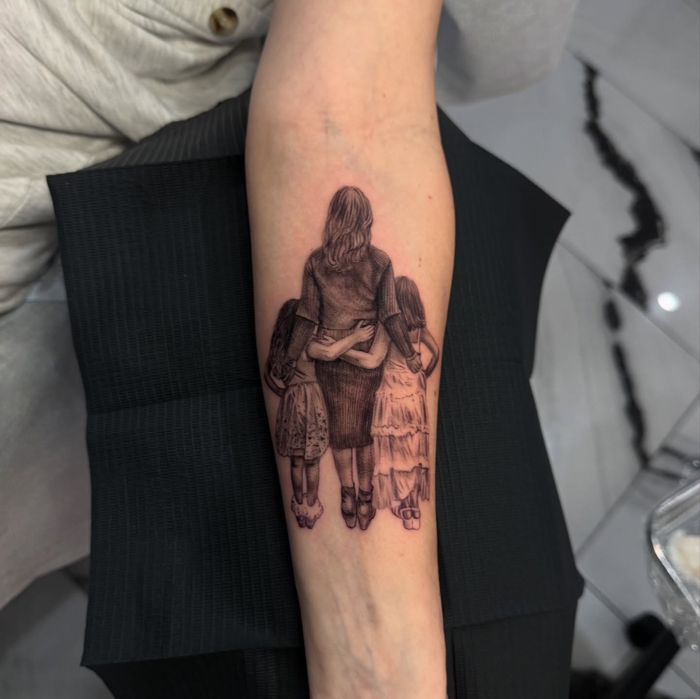 Mother and daughters realism tattoo on the forearm by Mia