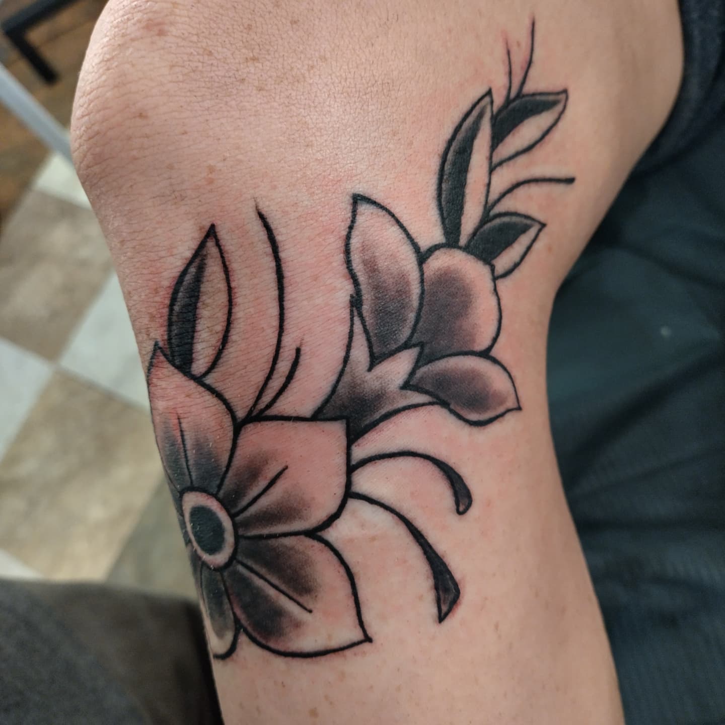 Flowers black and grey tattoo on the forearm by Matt Williamson