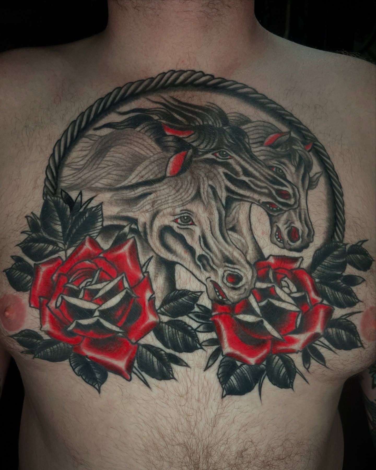 Horses and roses realism tattoo on the chest by Gilbert Gonzalez