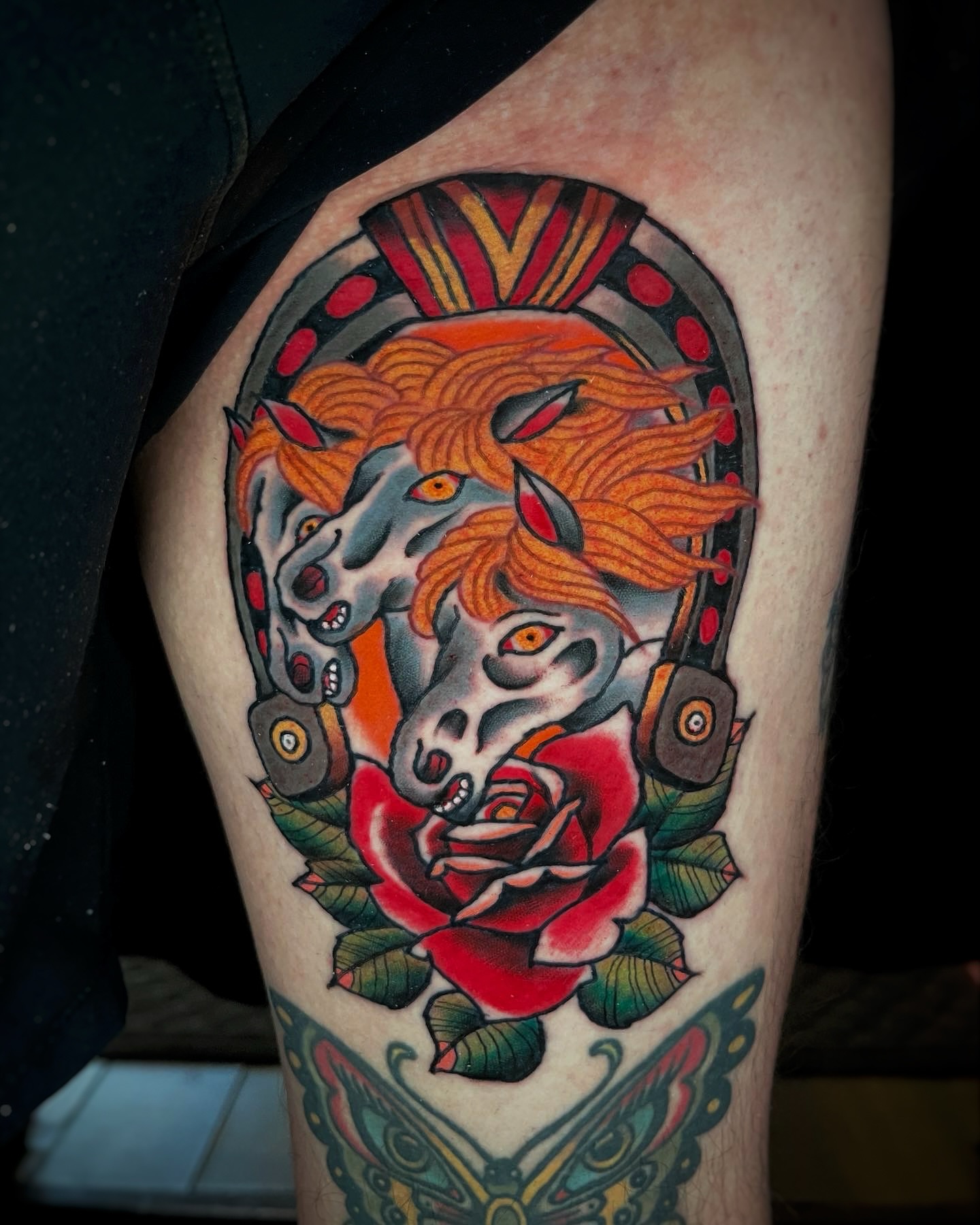 Horse and rose American traditional tattoo on the thigh by Gilbert Gonzalez
