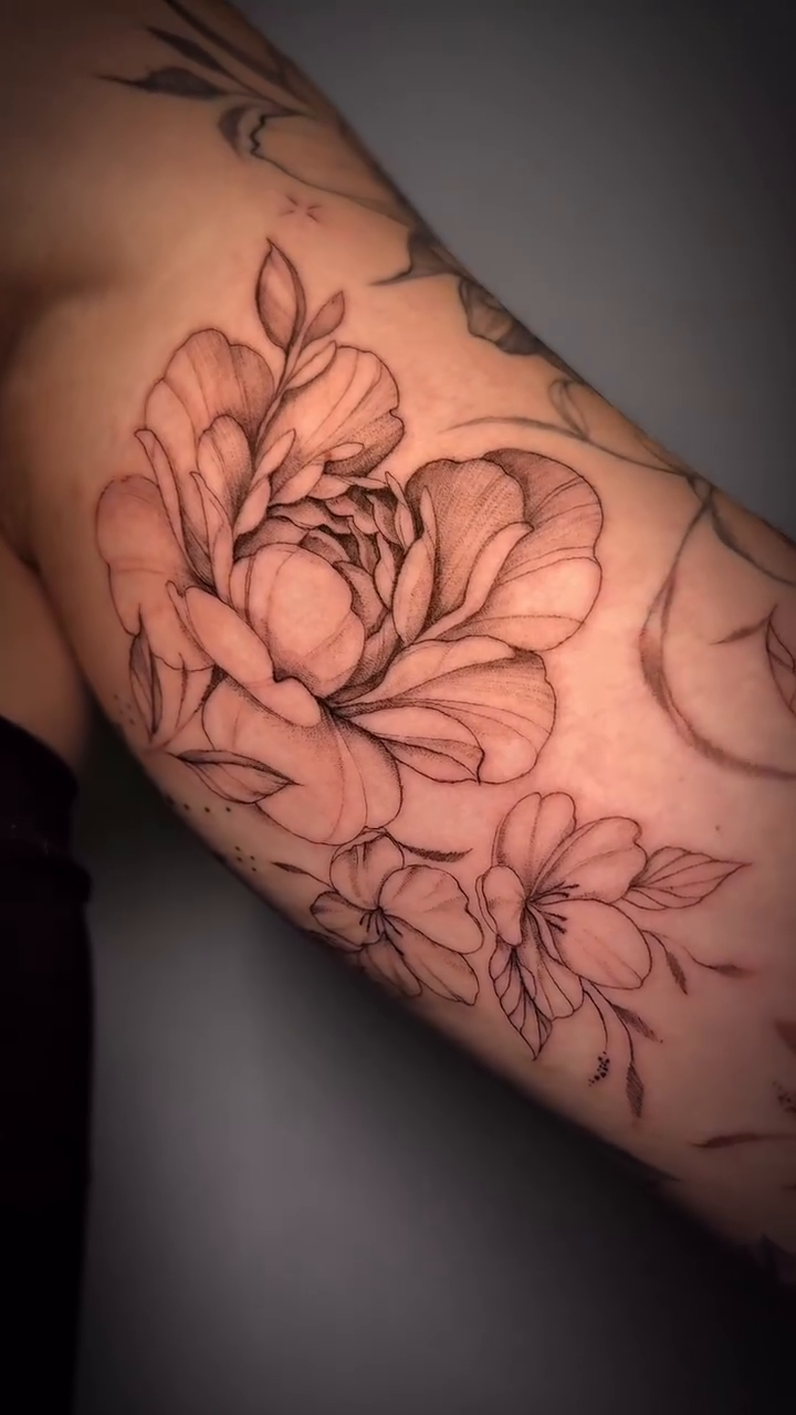 Peony and crescent moon dotwork tattoo on the upper arm by Nyc Tattoo Manhattan