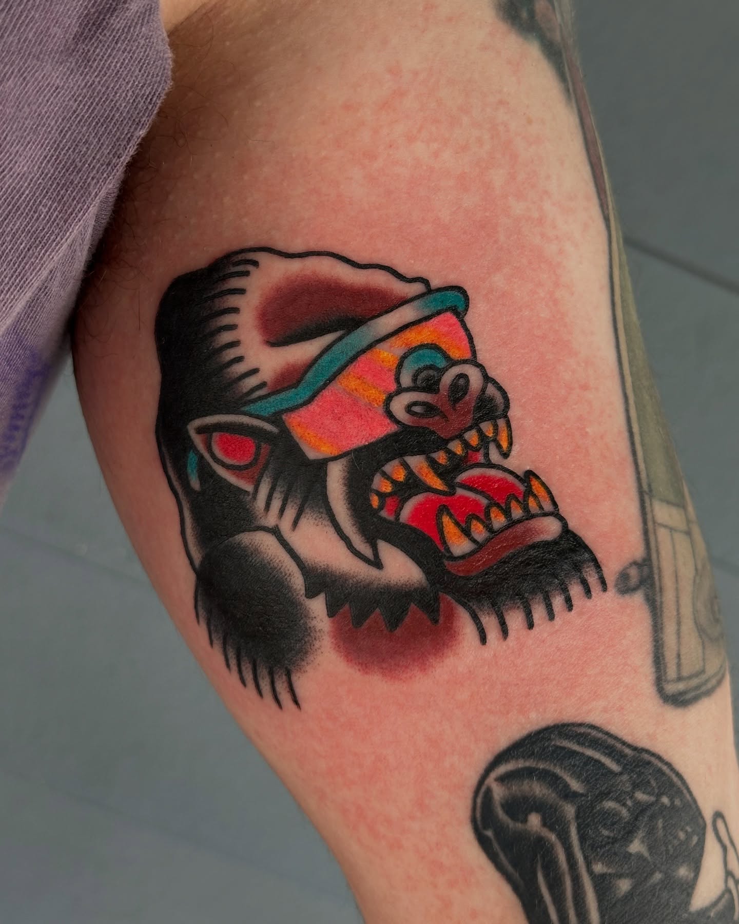 Ape with blindfold American traditional tattoo on the forearm by Michael Williams