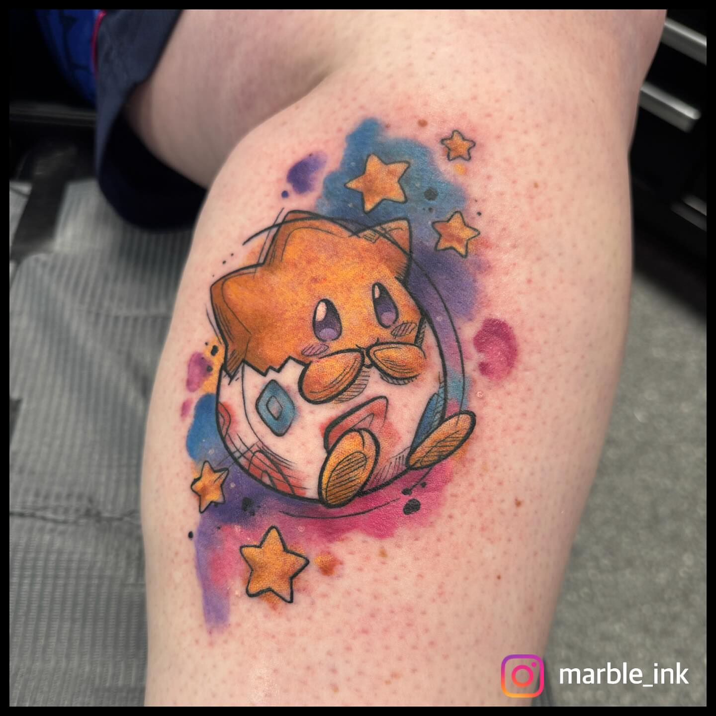 Star watercolor tattoo on the thigh by Darbi "Marbles"