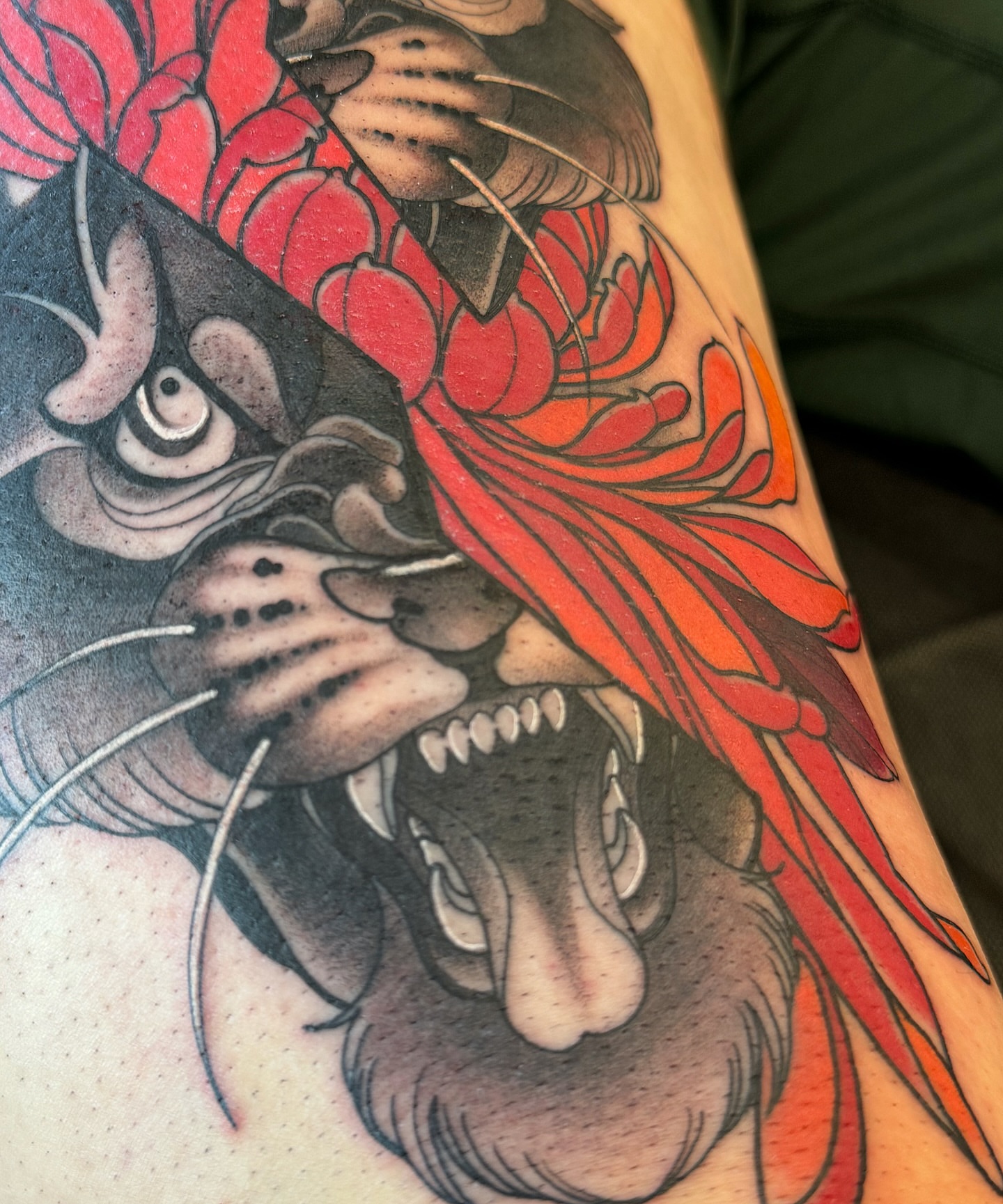 Lion and phoenix japanese irezumi tattoo on the forearm by Anne Cornelson