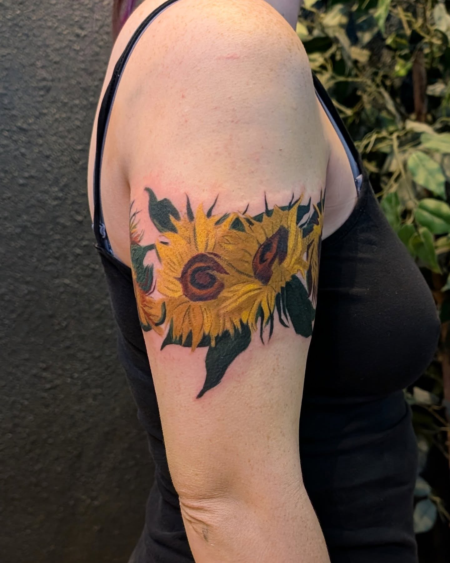 Sunflowers realism tattoo on the upper arm by Jhenn