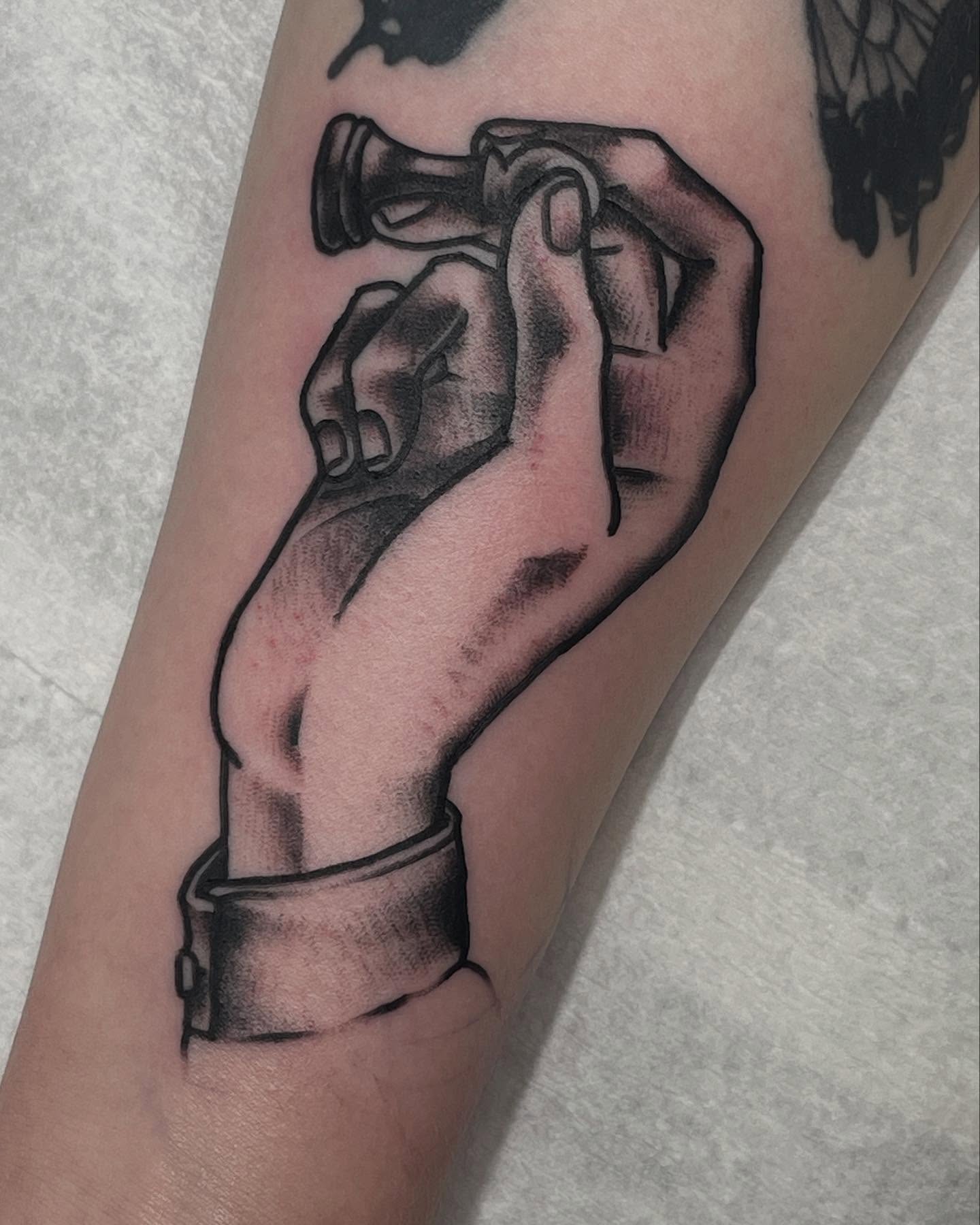 Hand with handcuffs black and grey tattoo on the forearm by G. Clover ⚧︎, Chicago, Illinois